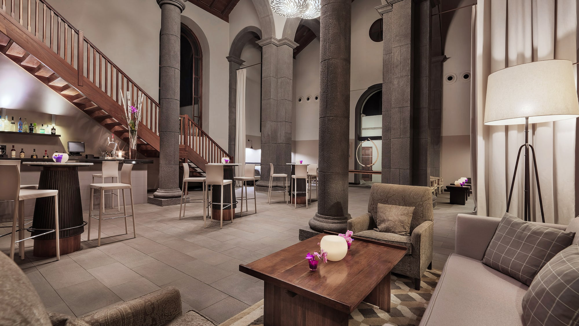 a room with columns and a table and chairs