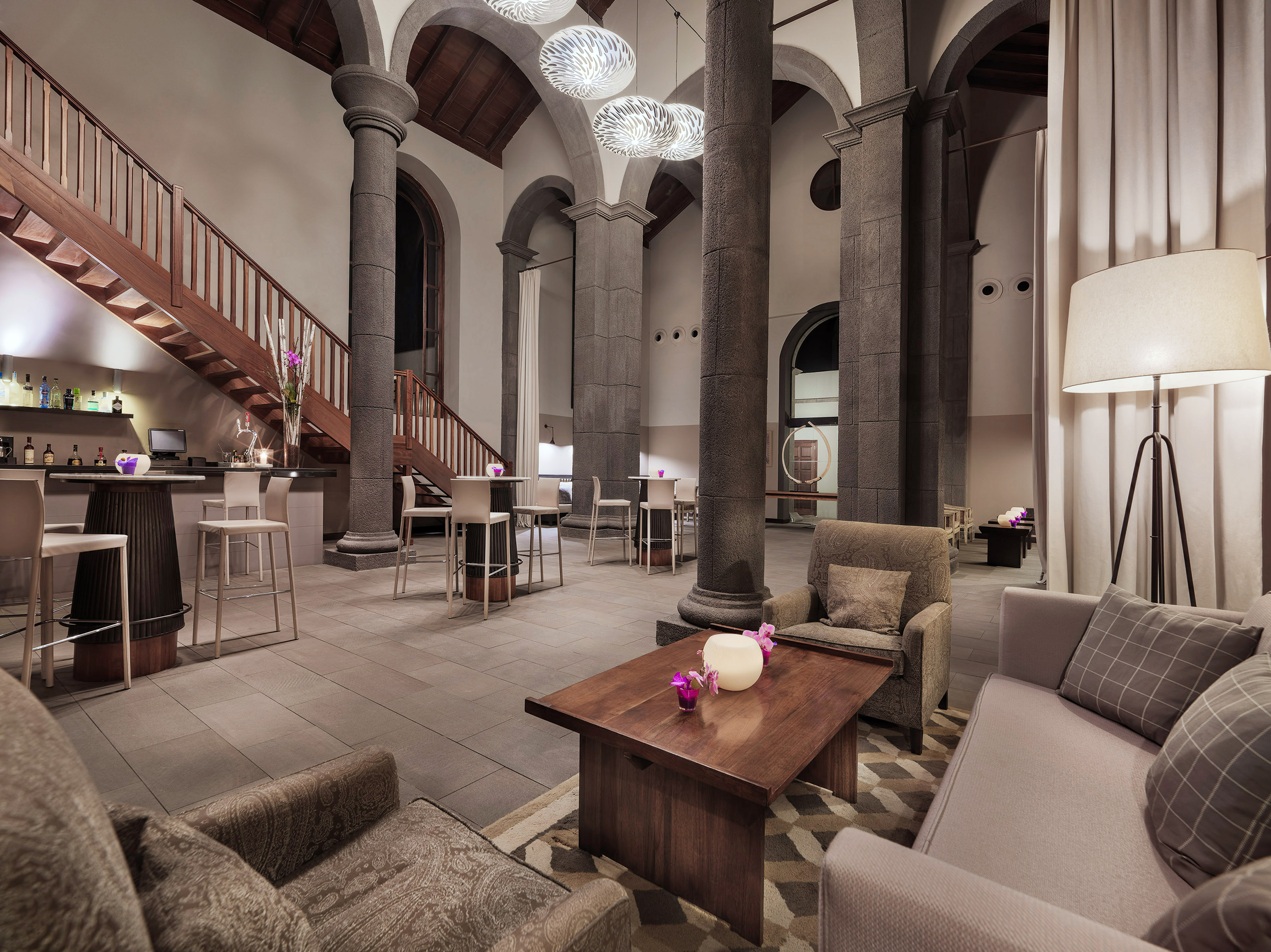 a room with columns and a table and chairs