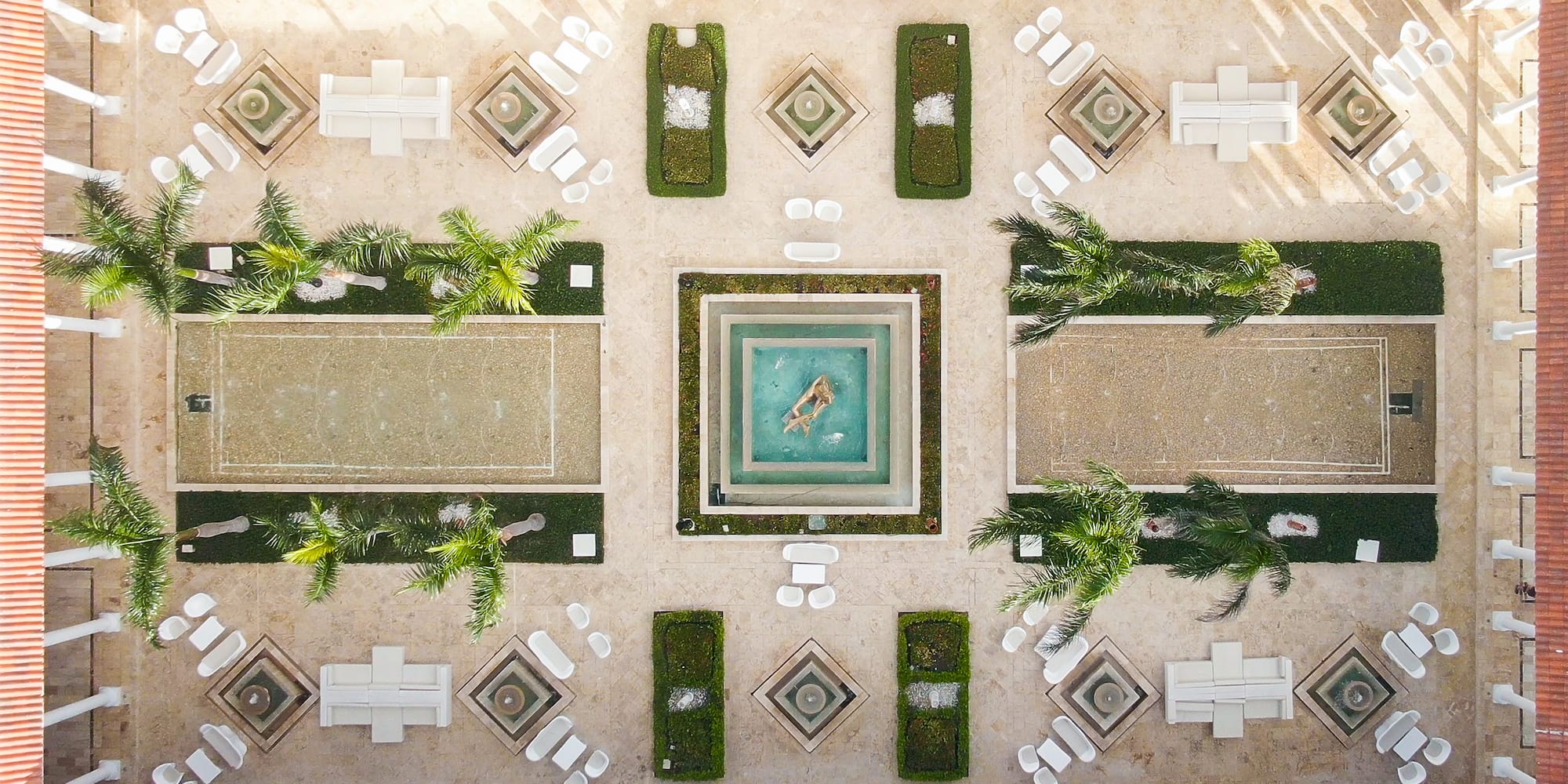 a courtyard with a pool and chairs