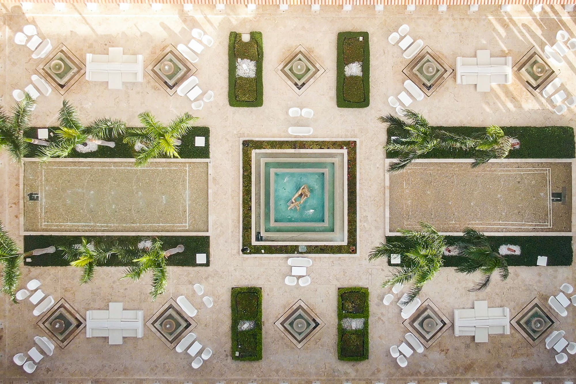 a courtyard with a pool and chairs
