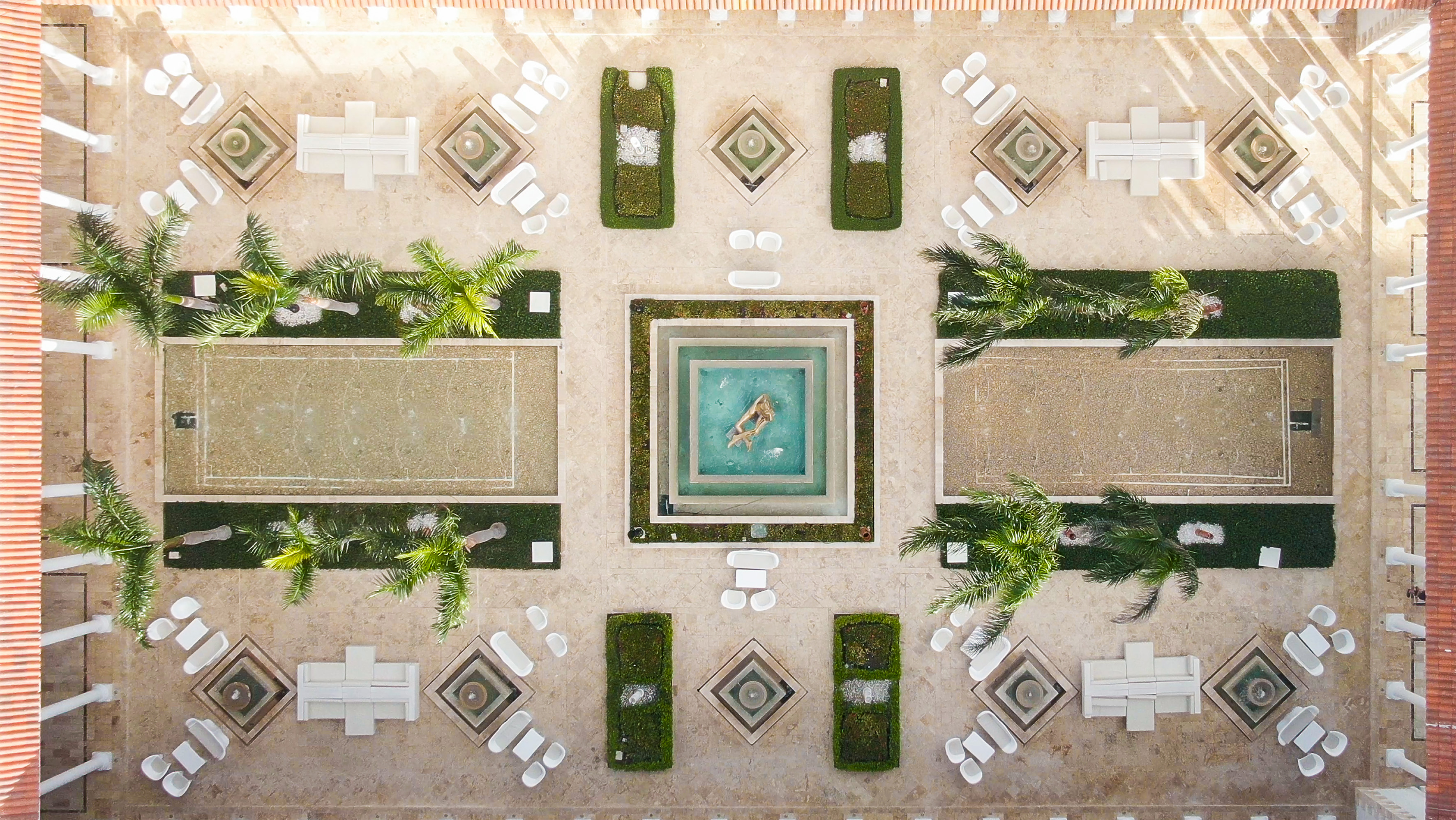 a courtyard with a pool and chairs