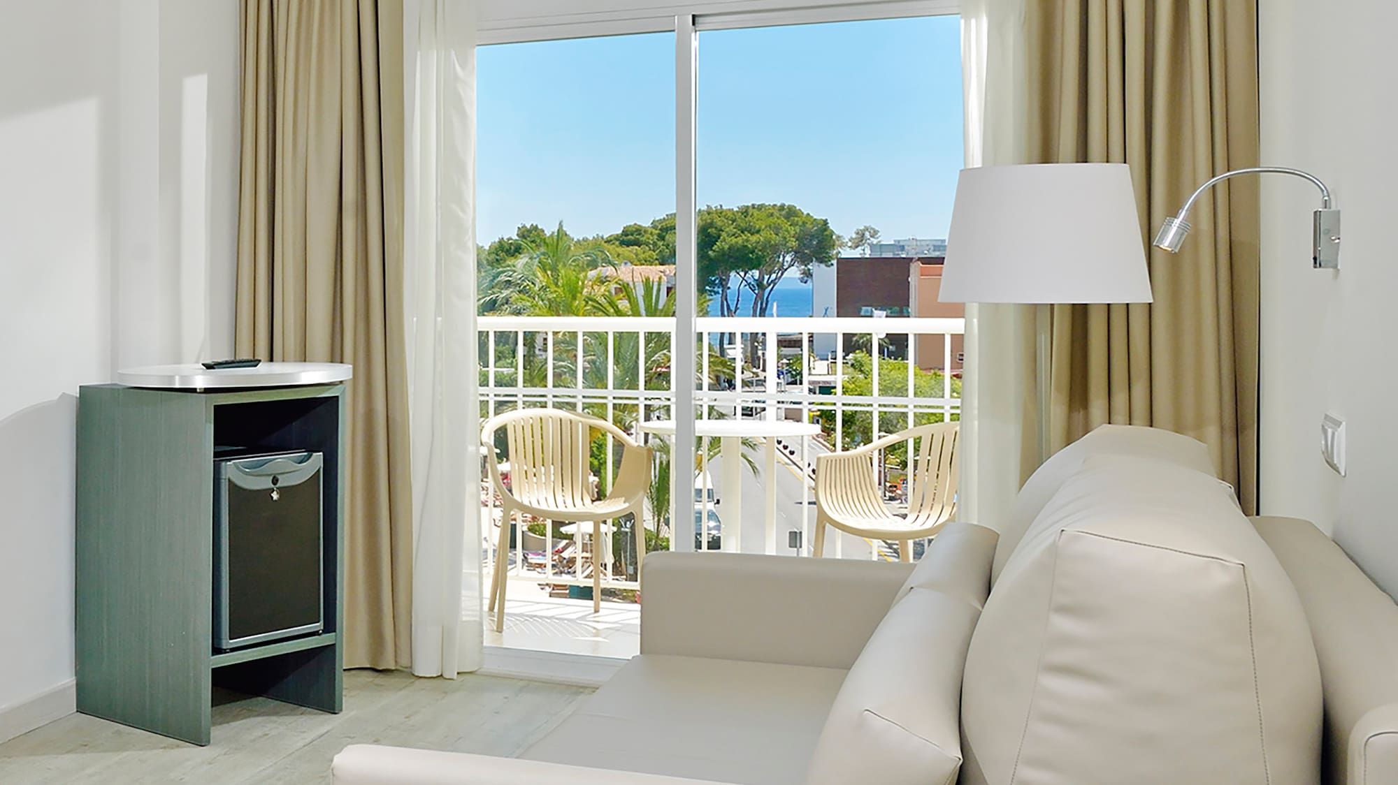 a room with a couch and a table and a lamp