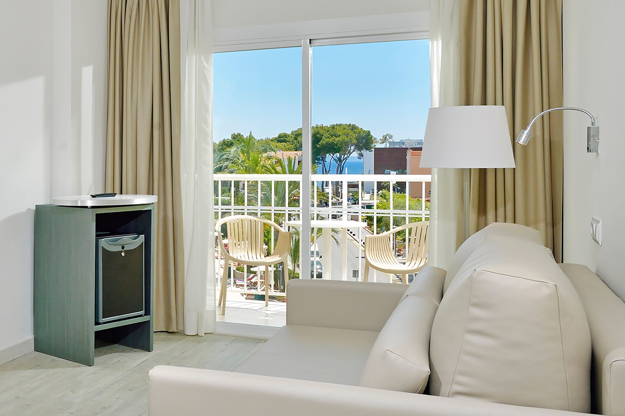 a room with a couch and a table and a lamp