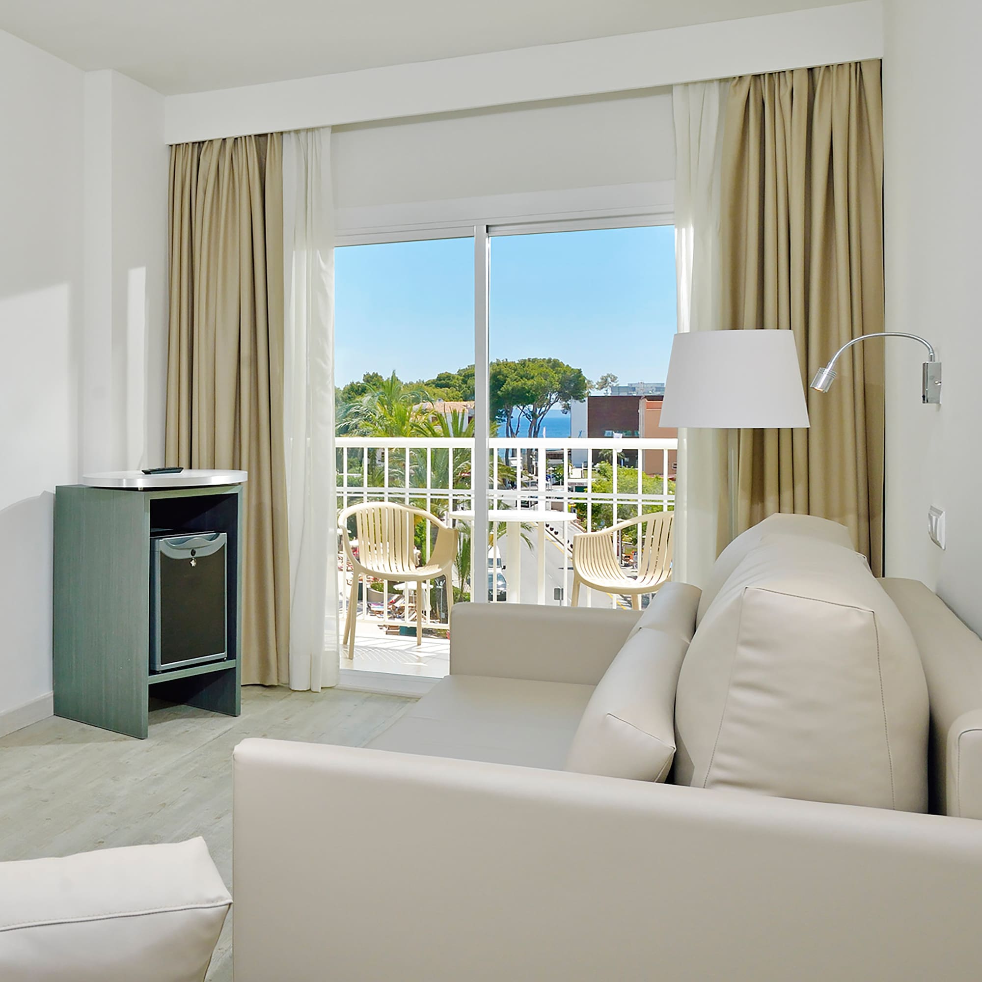 a room with a couch and a table and a lamp