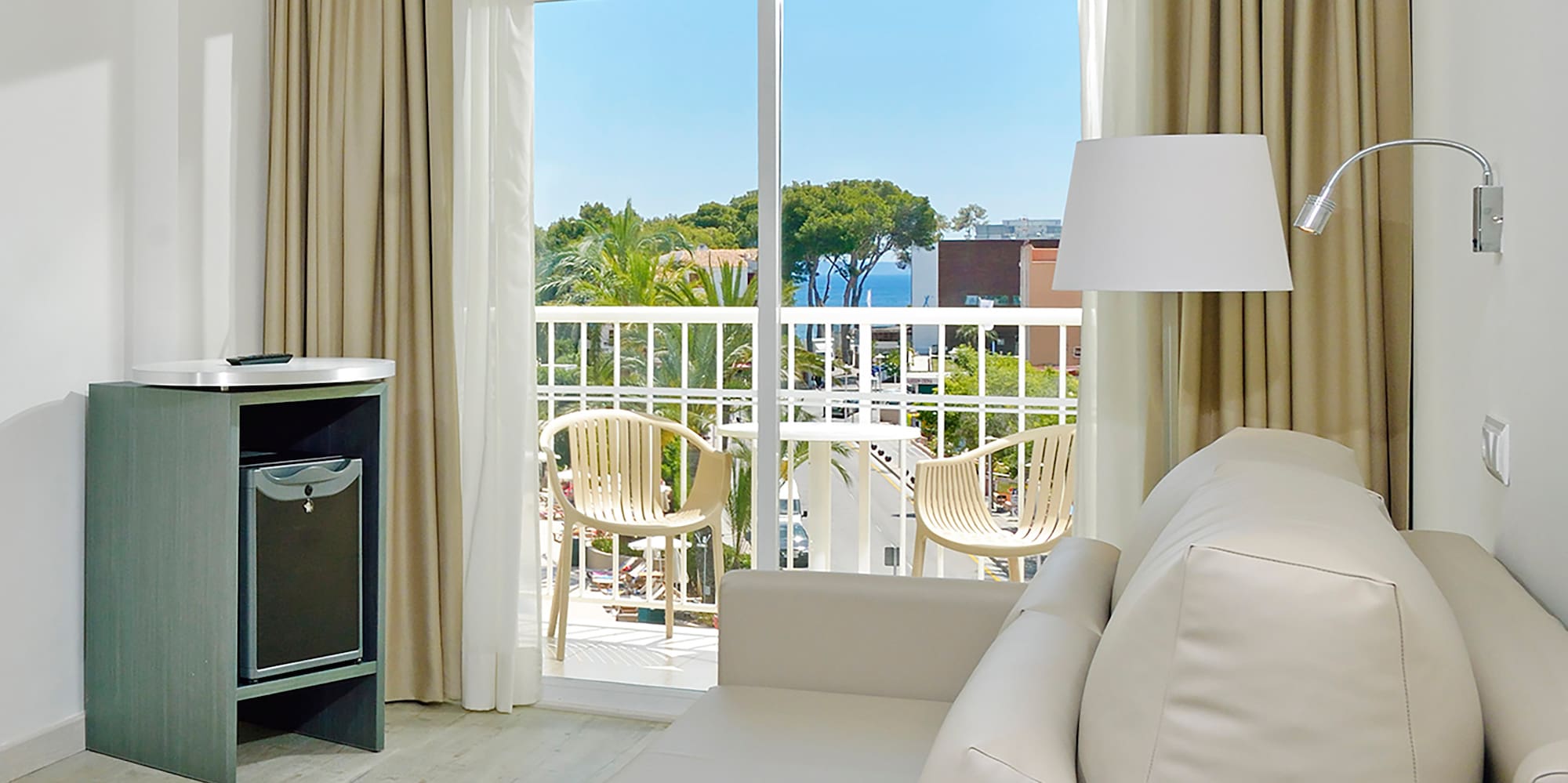 a room with a couch and a table and a lamp