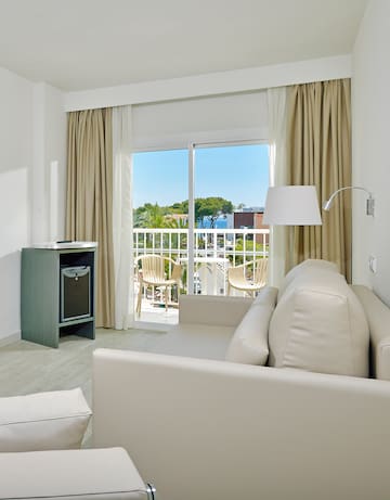 a room with a couch and a table and a lamp