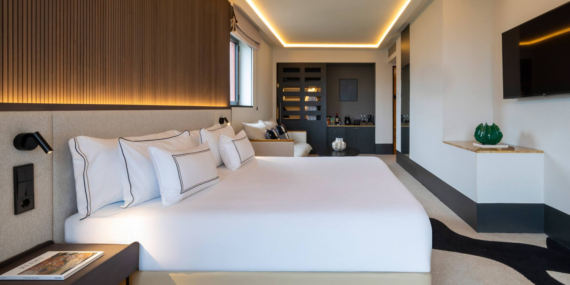 a bathroom with marble countertops and a round mirror