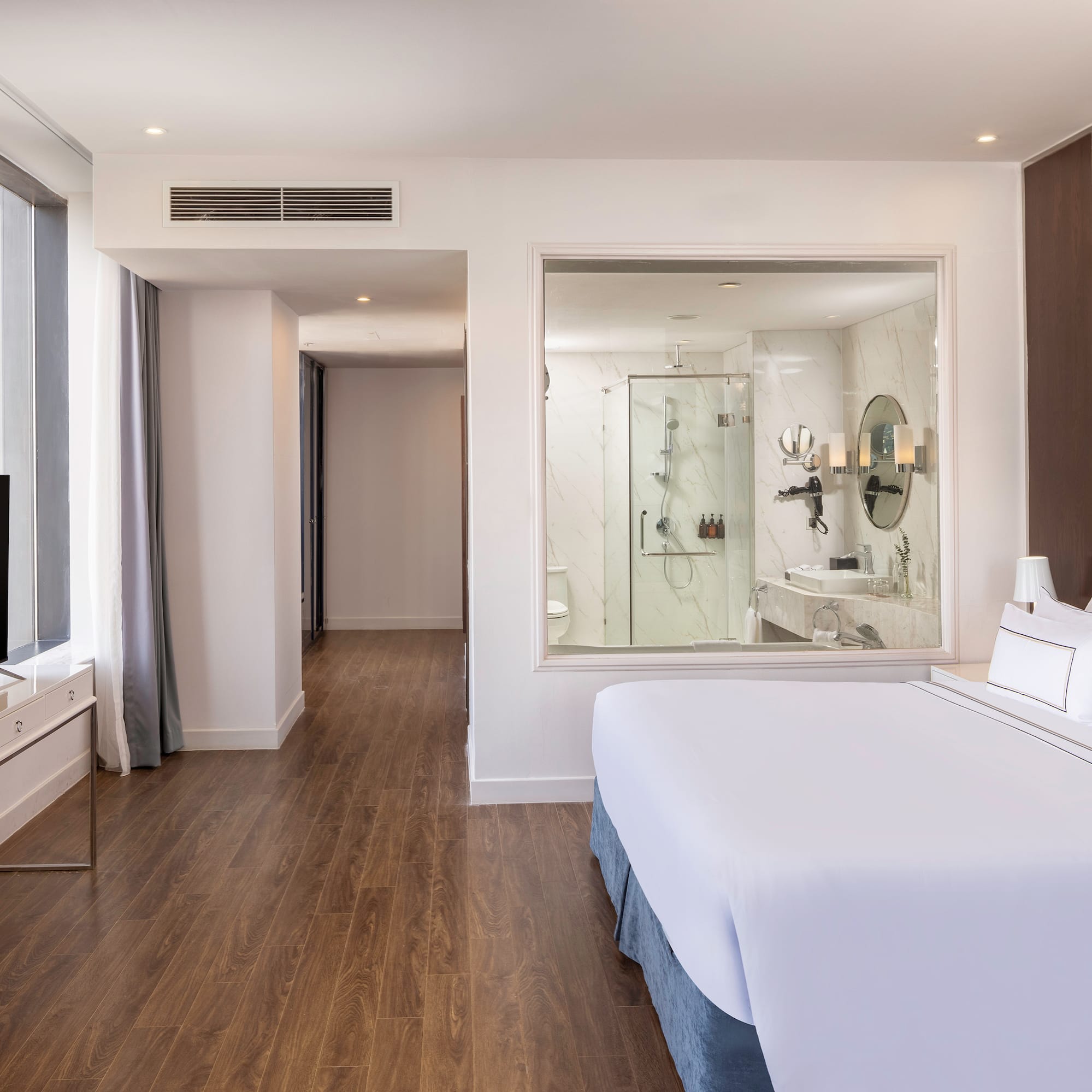 a bedroom with a large window and a television