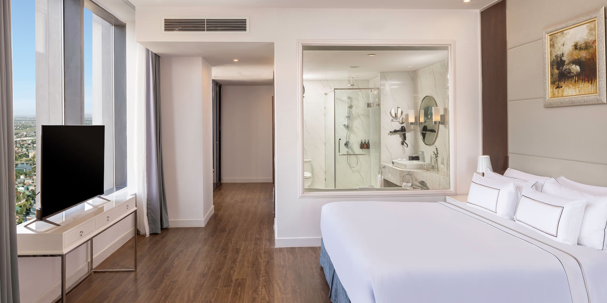 a bedroom with a large window and a television