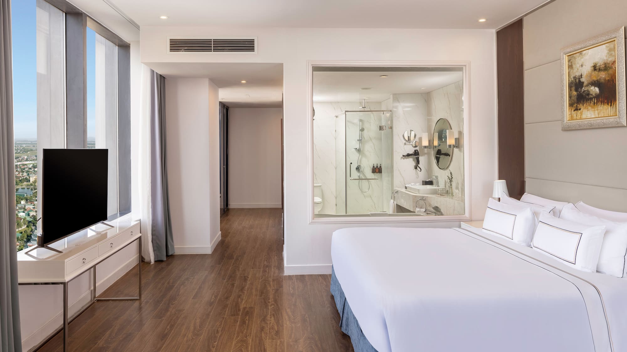 a bedroom with a large window and a television