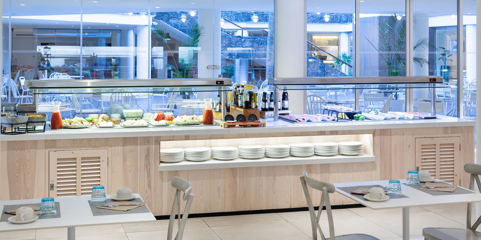 a buffet with plates and food on the counter