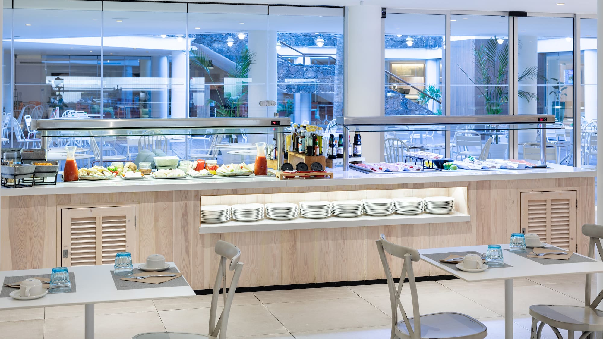 a buffet with plates and food on the counter