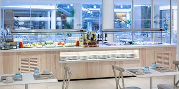 a buffet with plates and food on the counter