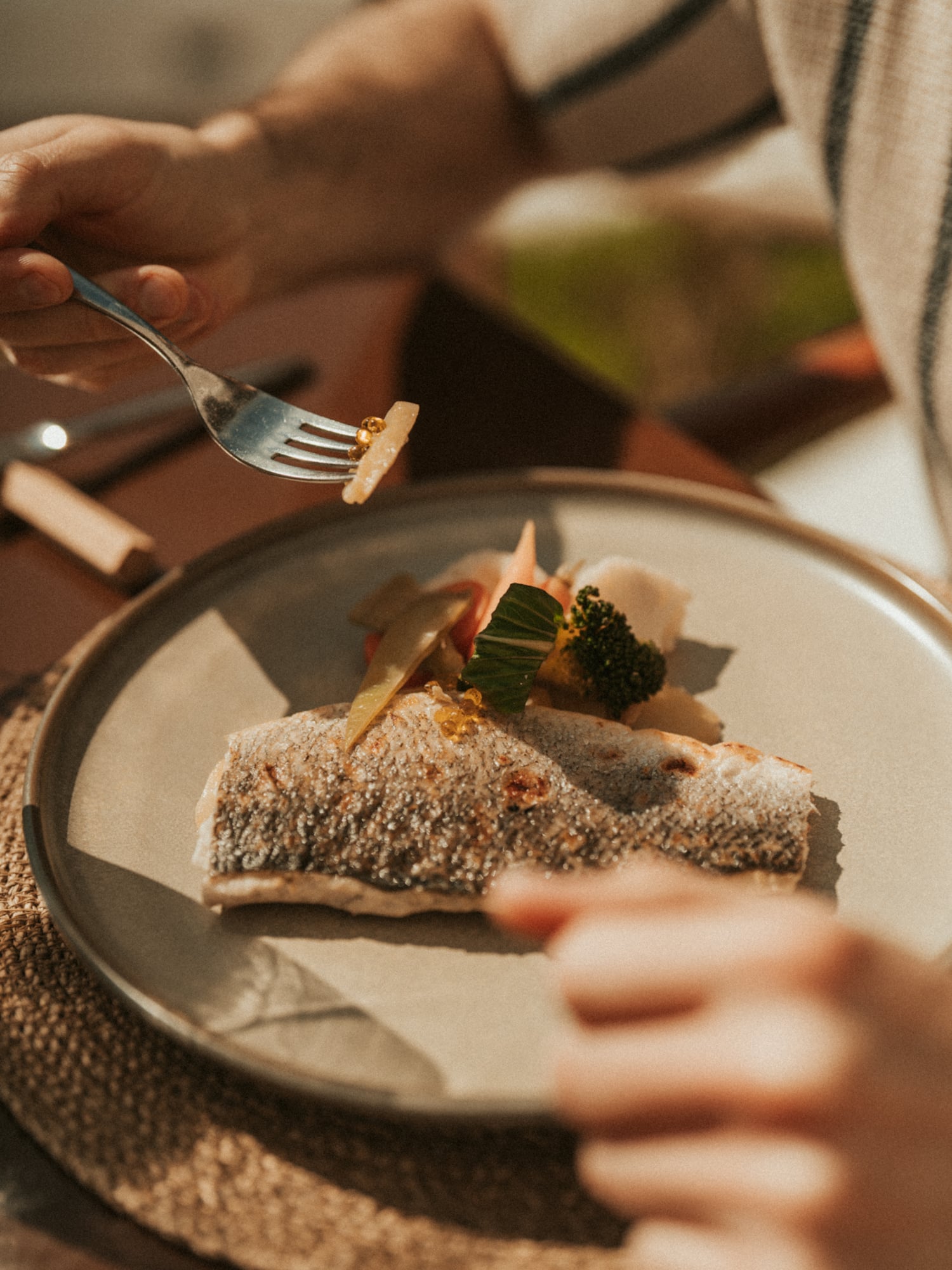 a person eating a fish with a fork