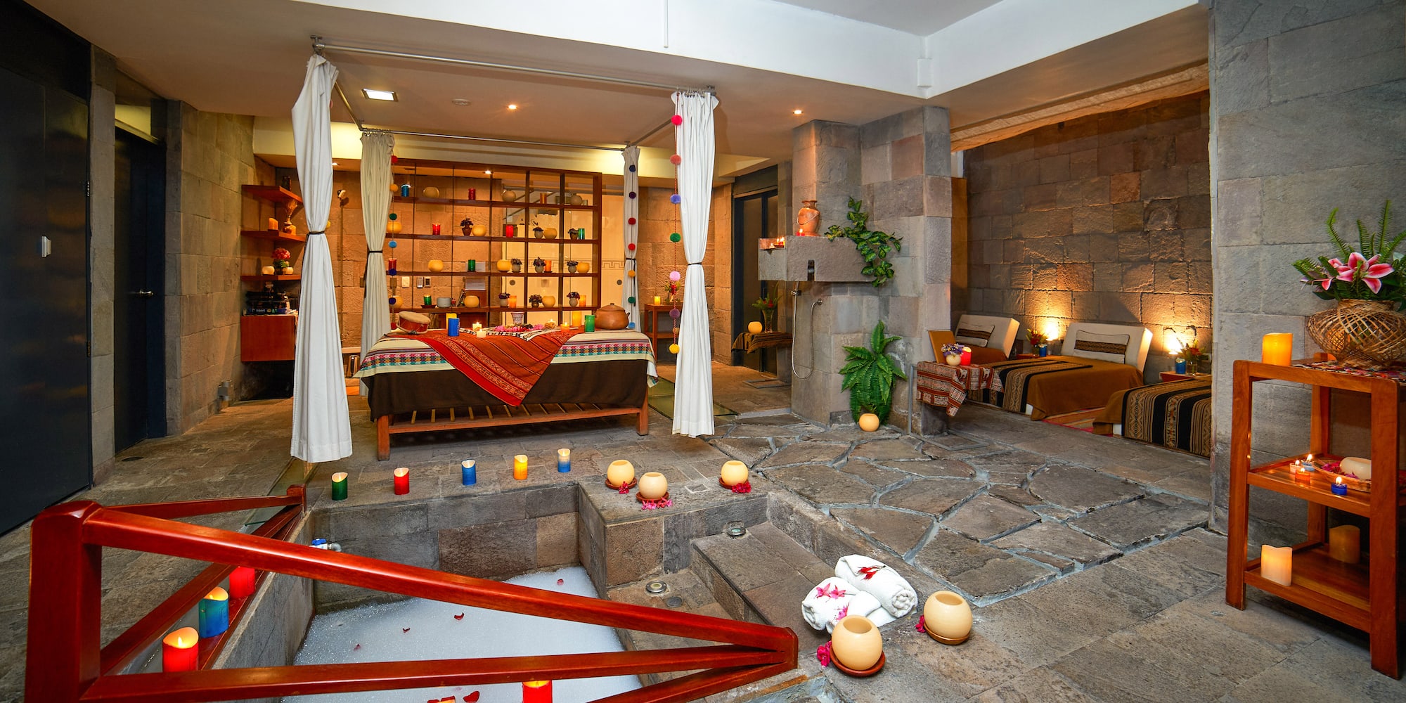 a room with a bed and candles