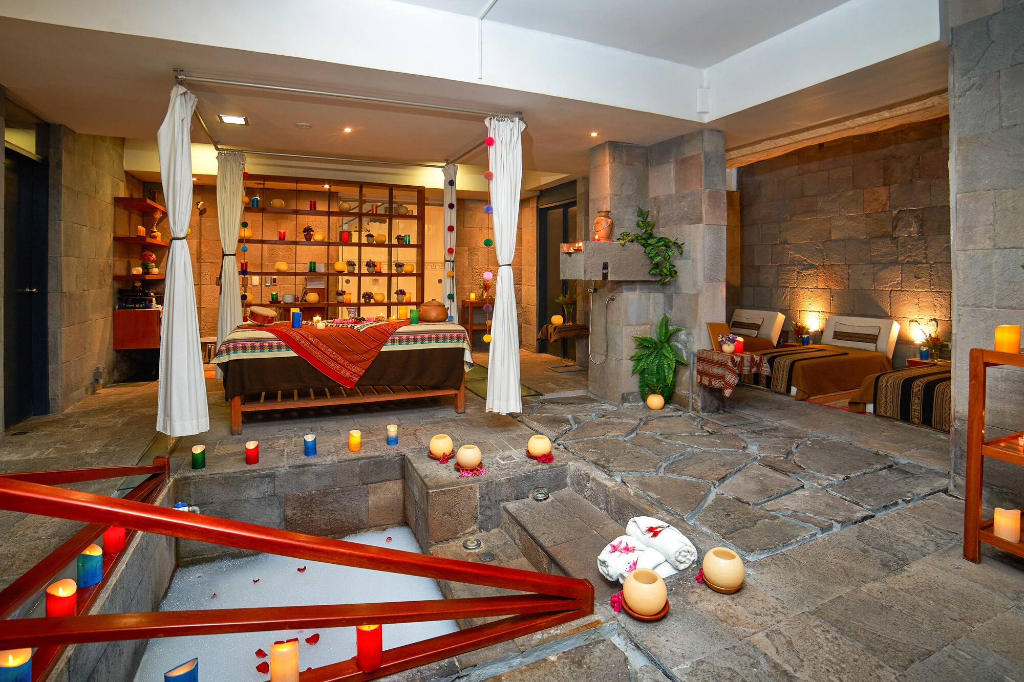 a room with a bed and candles