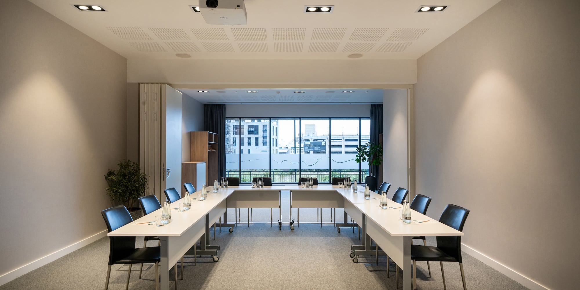 a room with long tables and chairs