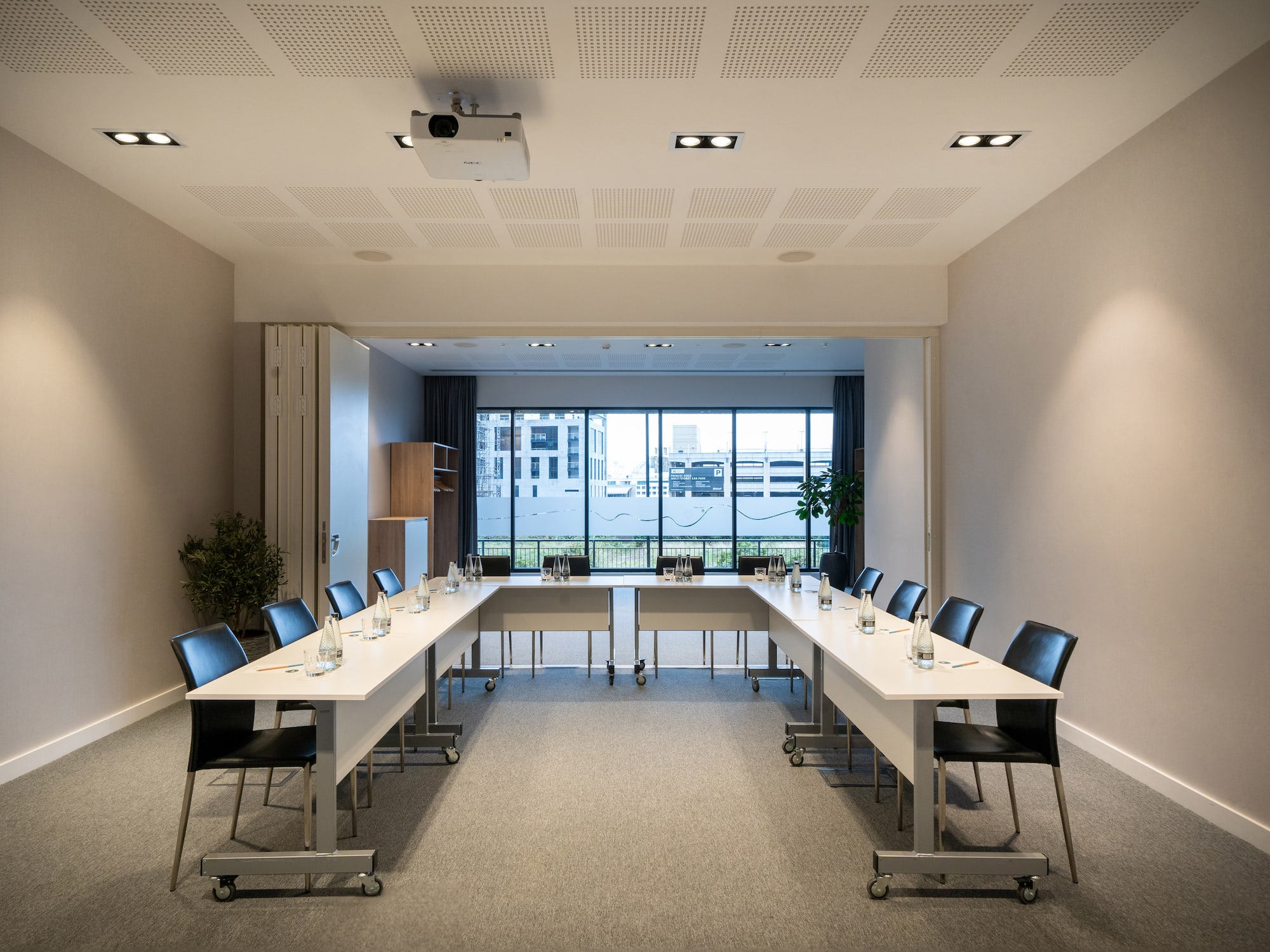 a room with long tables and chairs