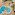 Aerial view: resort pools, kids' water park, sun loungers, palm trees.