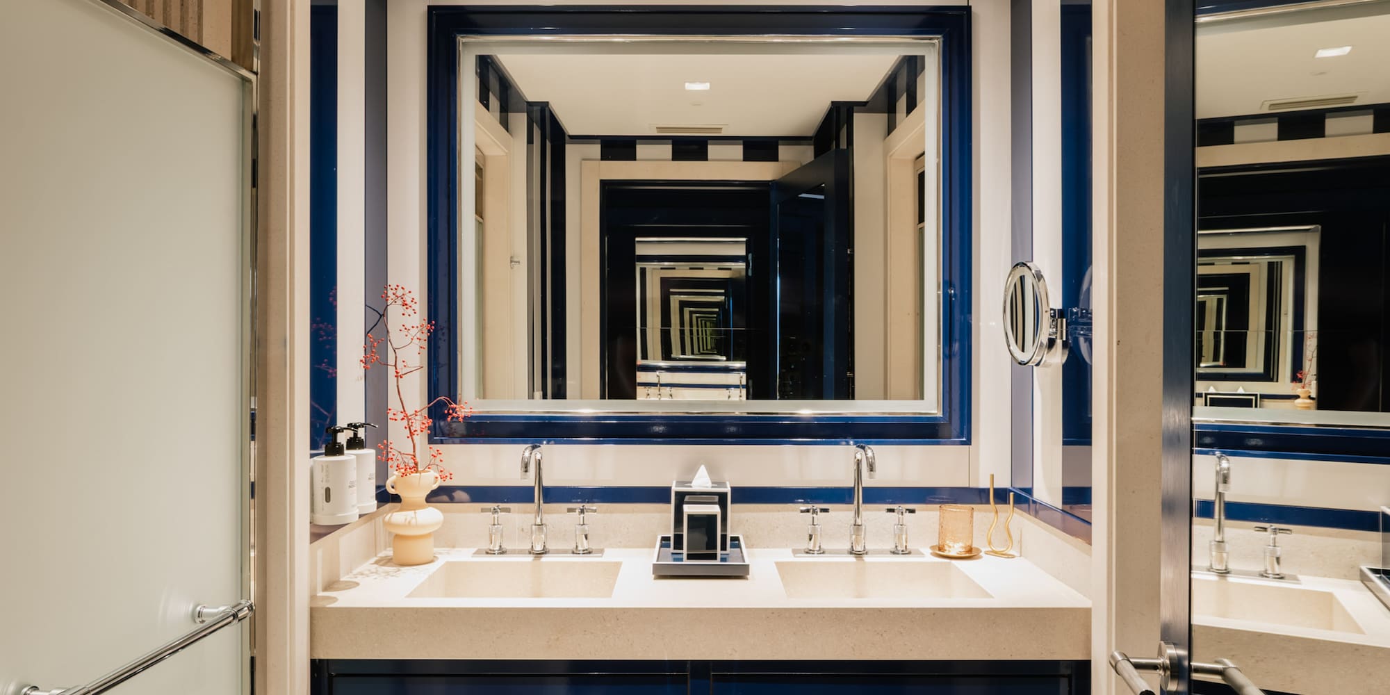 a bathroom with blue and white striped walls