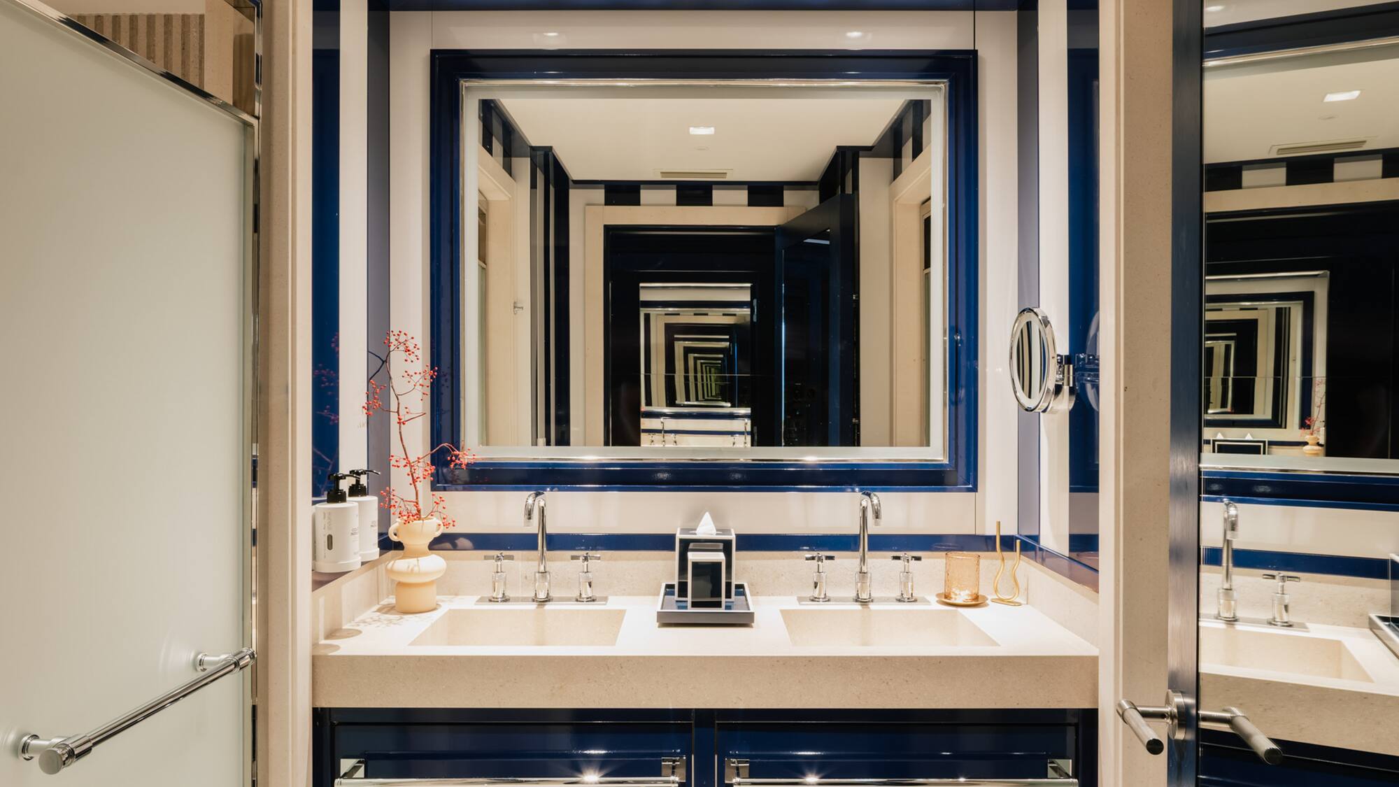 a bathroom with blue and white striped walls