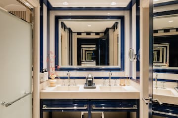a bathroom with blue and white striped walls