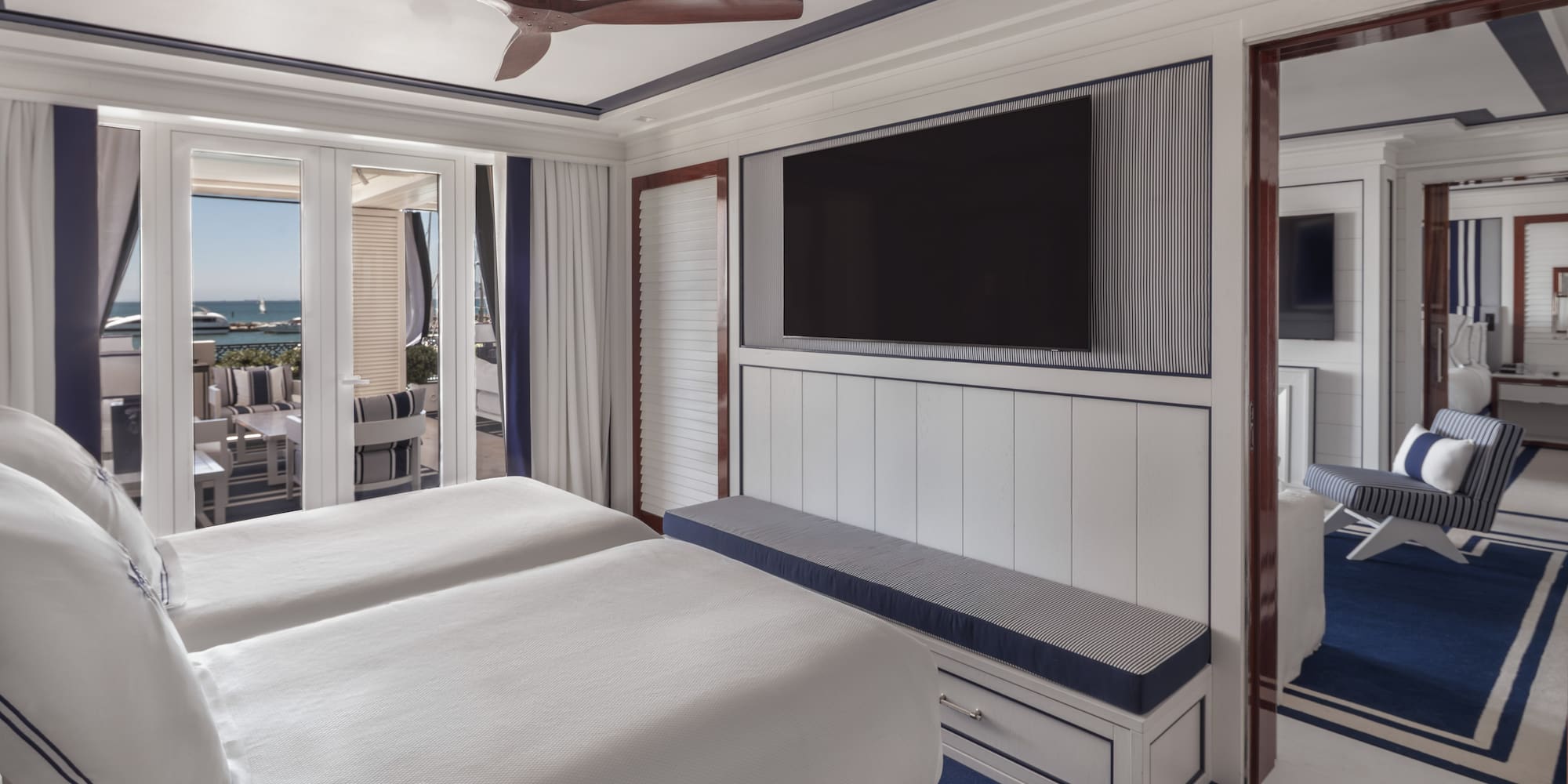 a room with two beds and a television