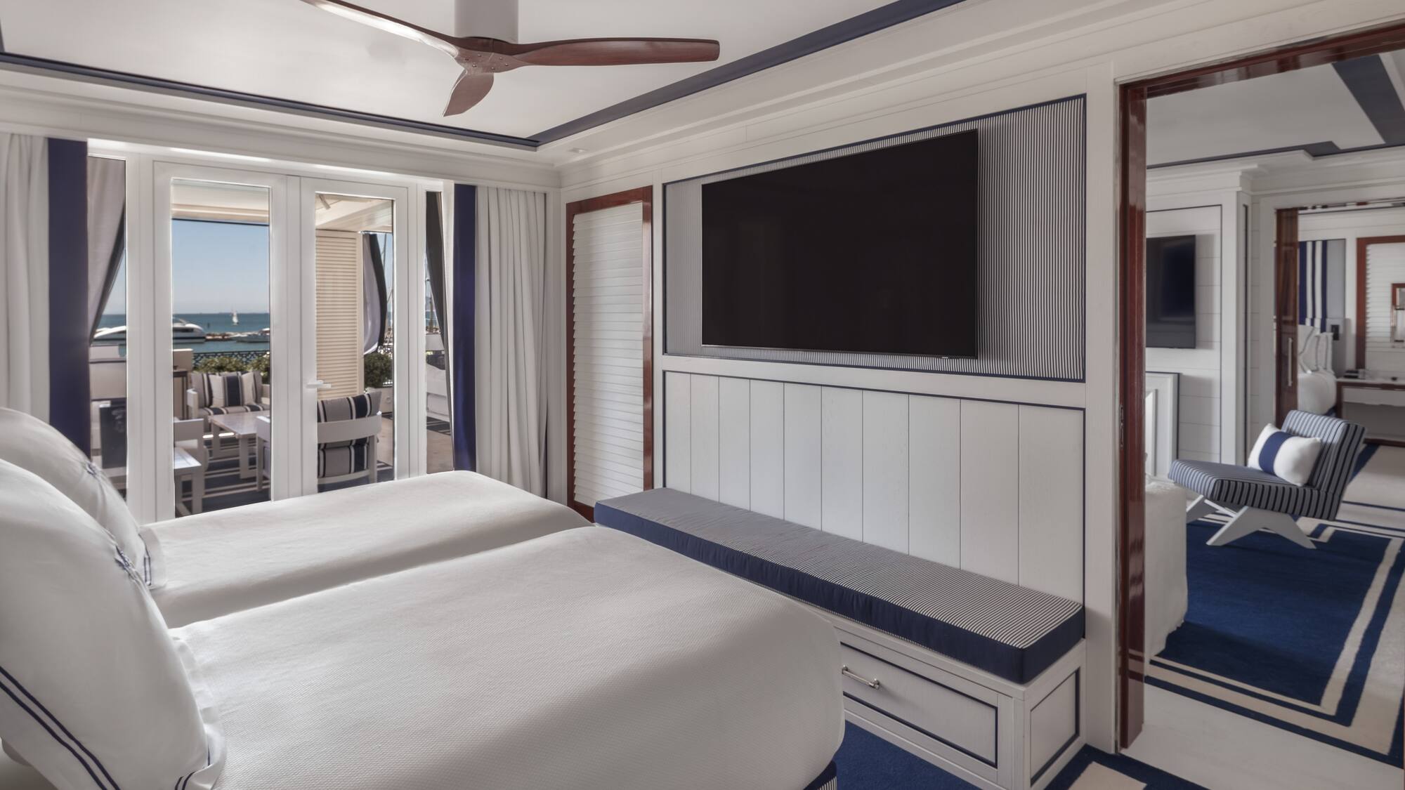 a room with two beds and a television