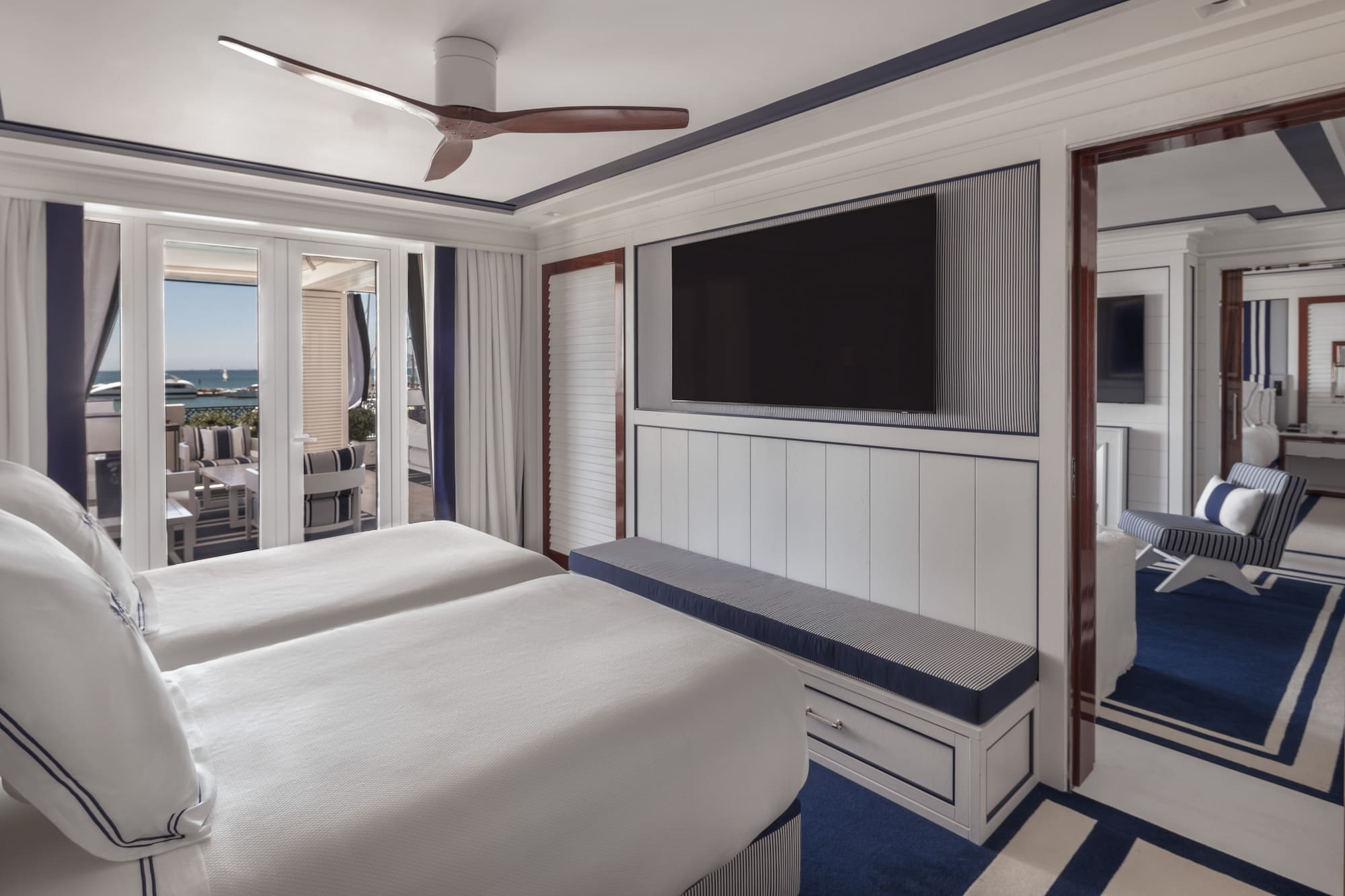 a room with two beds and a television