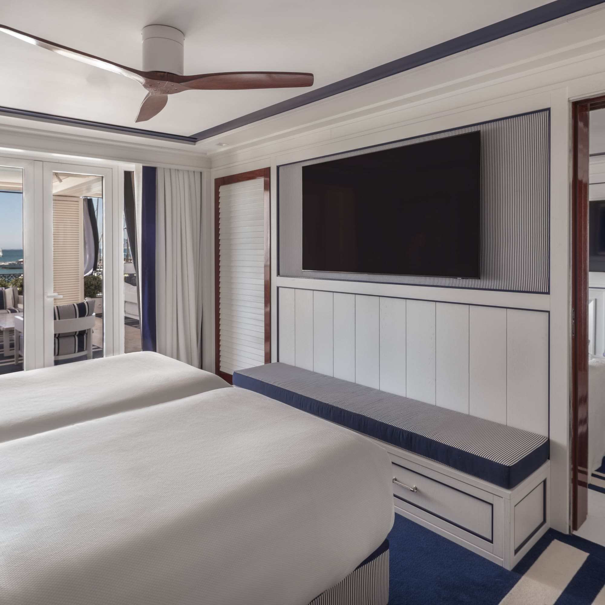 a room with two beds and a television