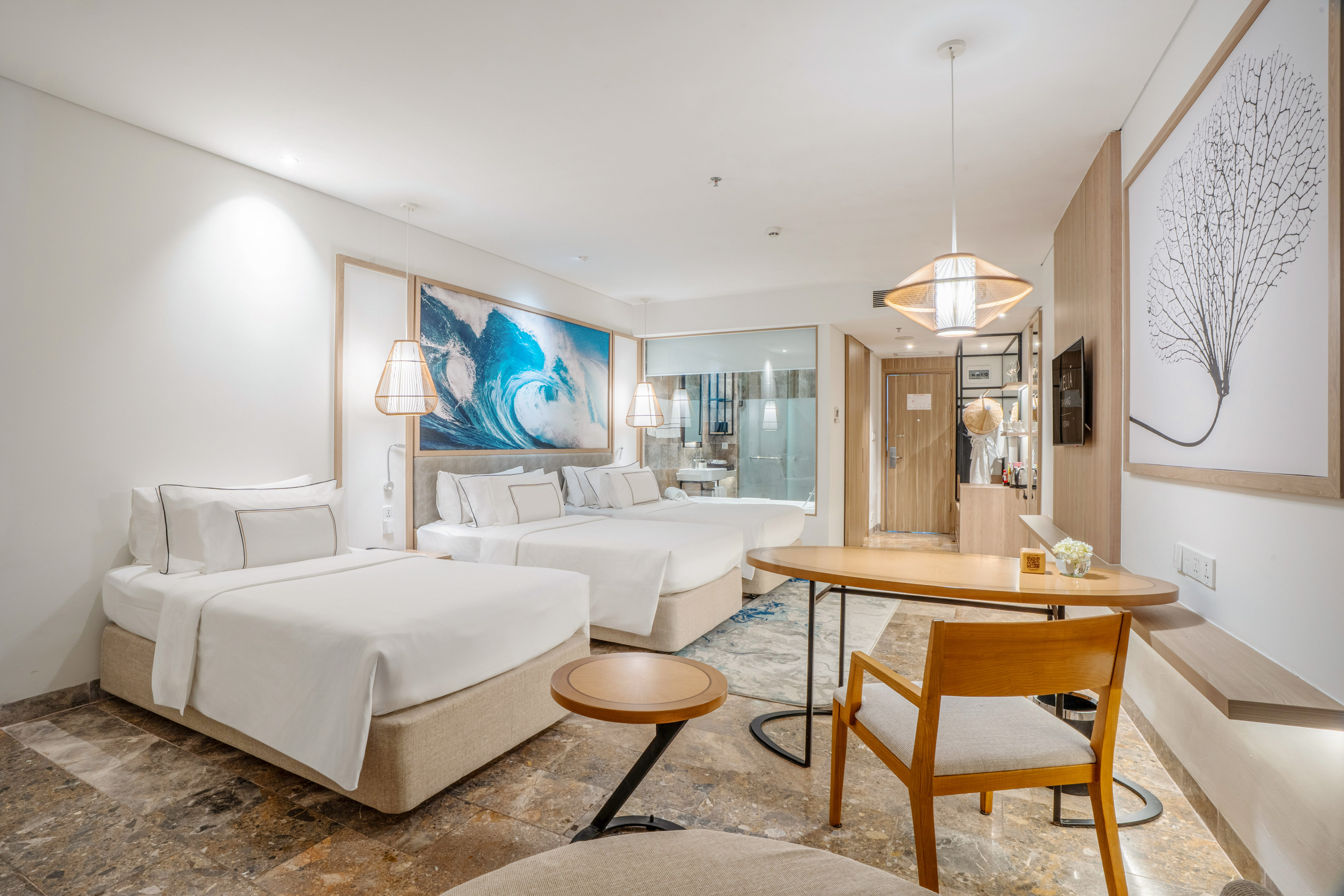 a room with two beds and a table