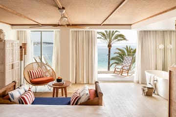 a room with a view of the ocean and a beach