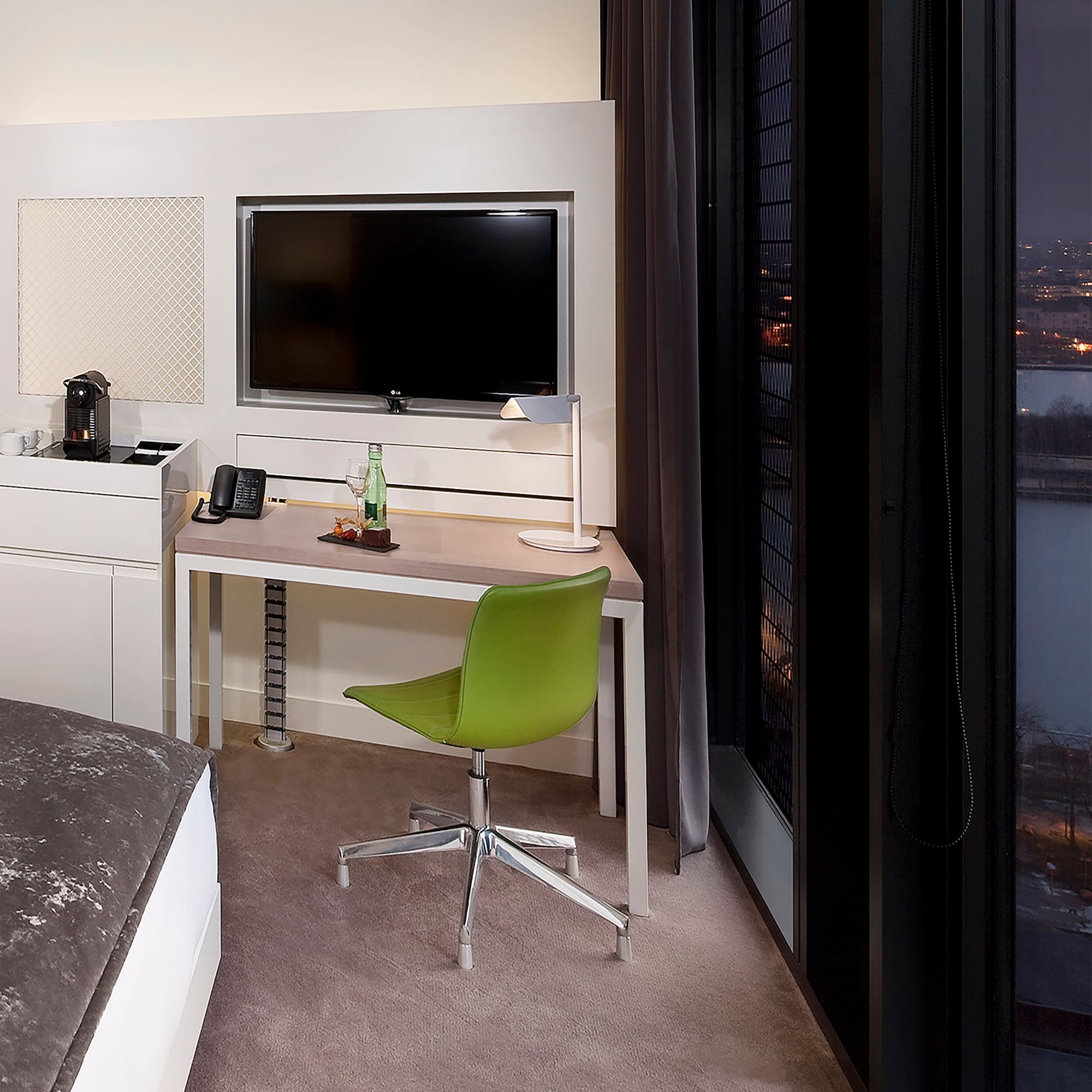 a room with a desk and a television