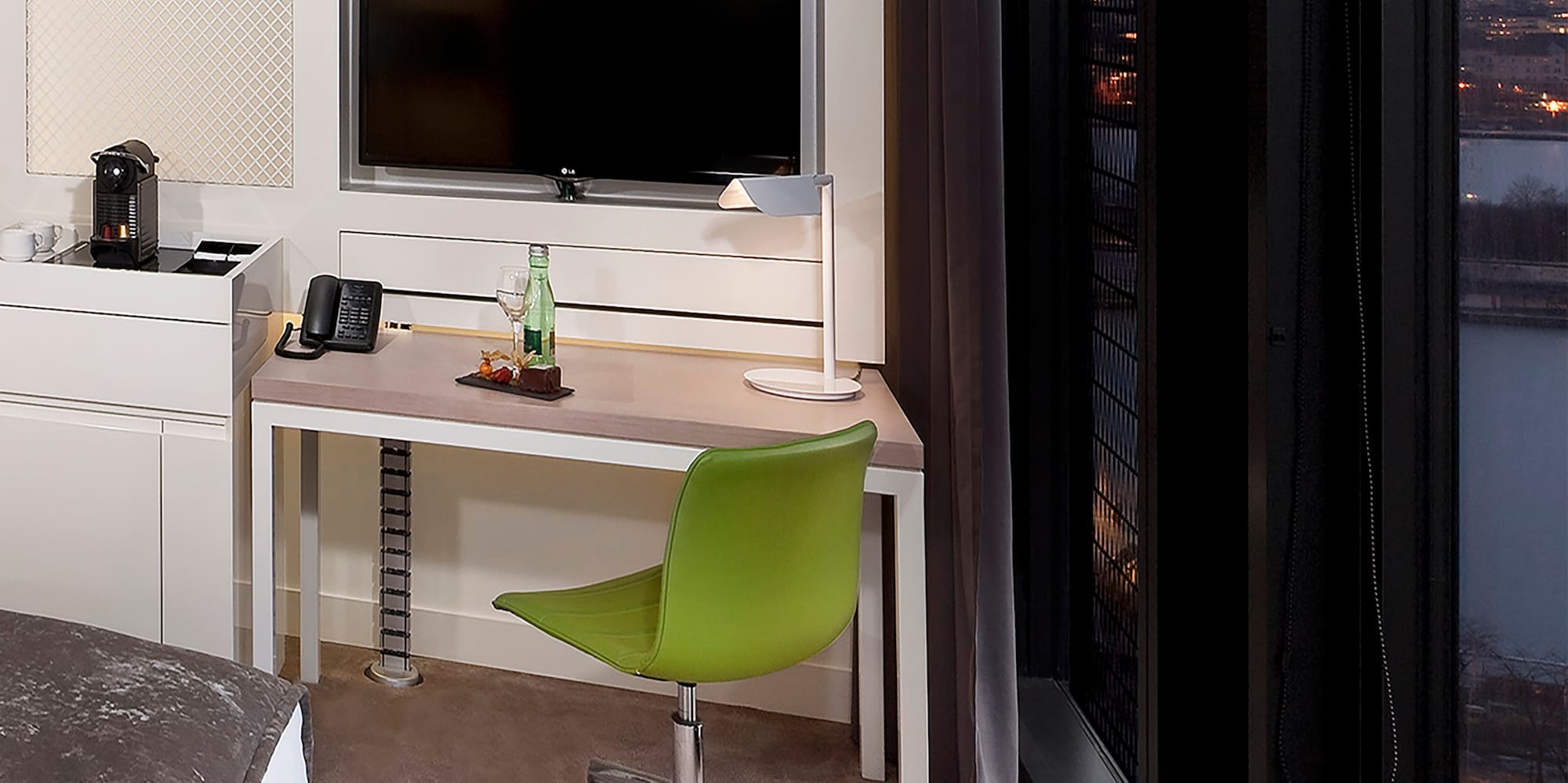 a room with a desk and a television