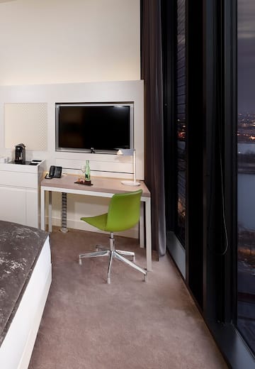 a room with a desk and a television