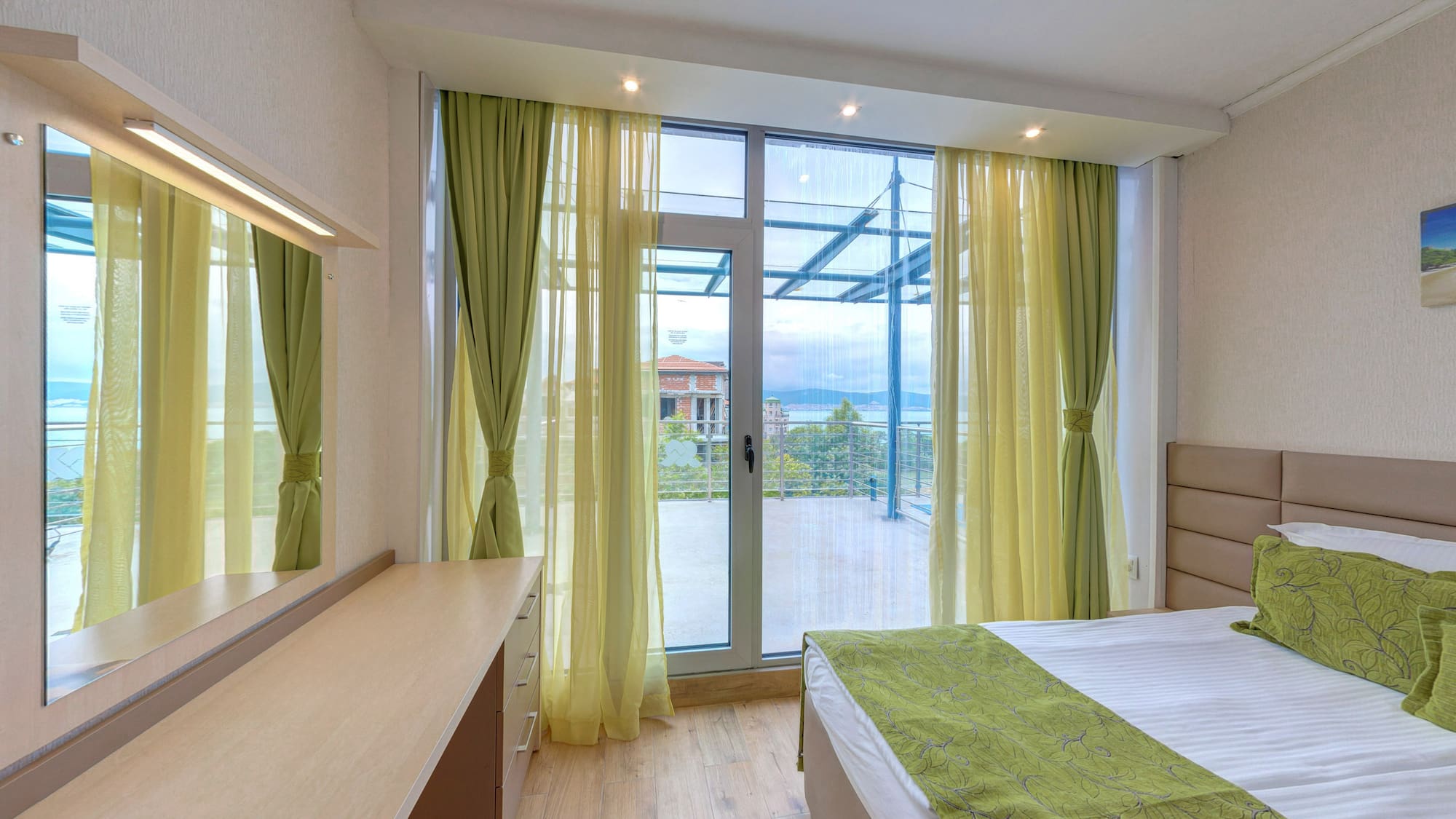a bedroom with green curtains and a window