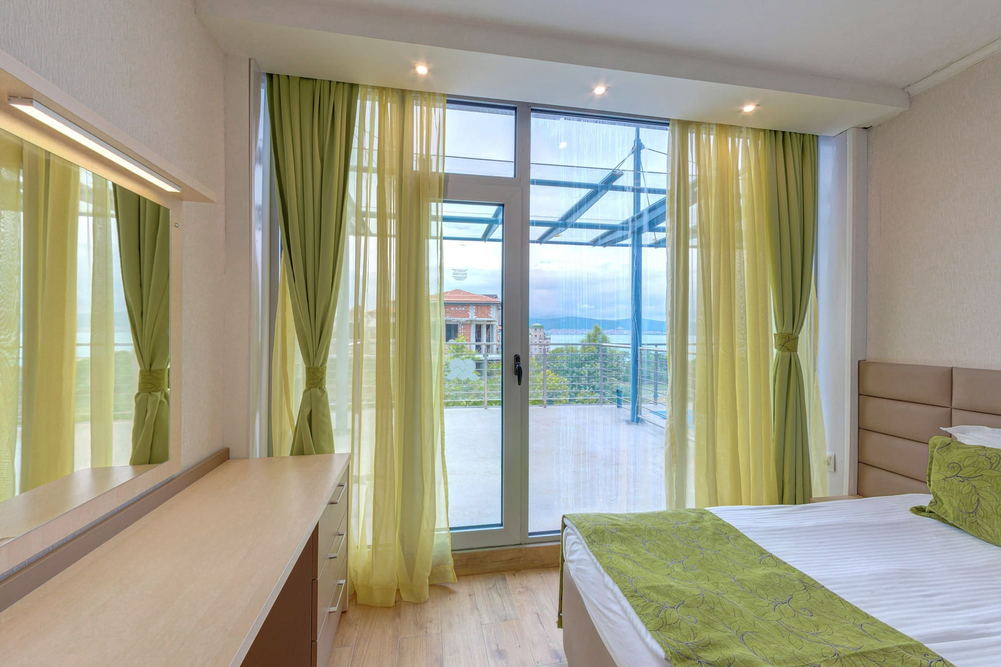 a bedroom with green curtains and a window