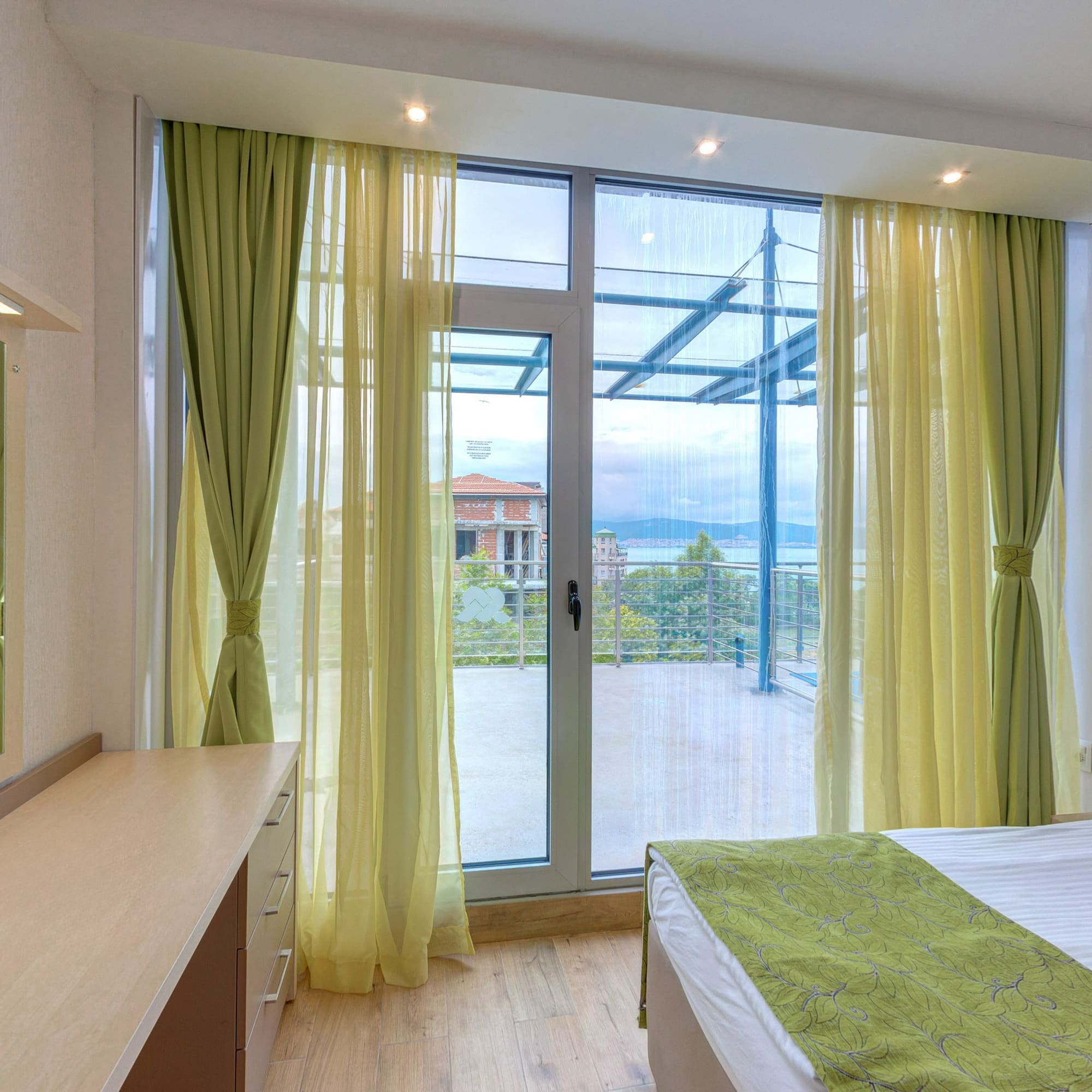 a bedroom with green curtains and a window