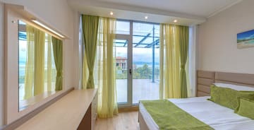 a bedroom with green curtains and a window
