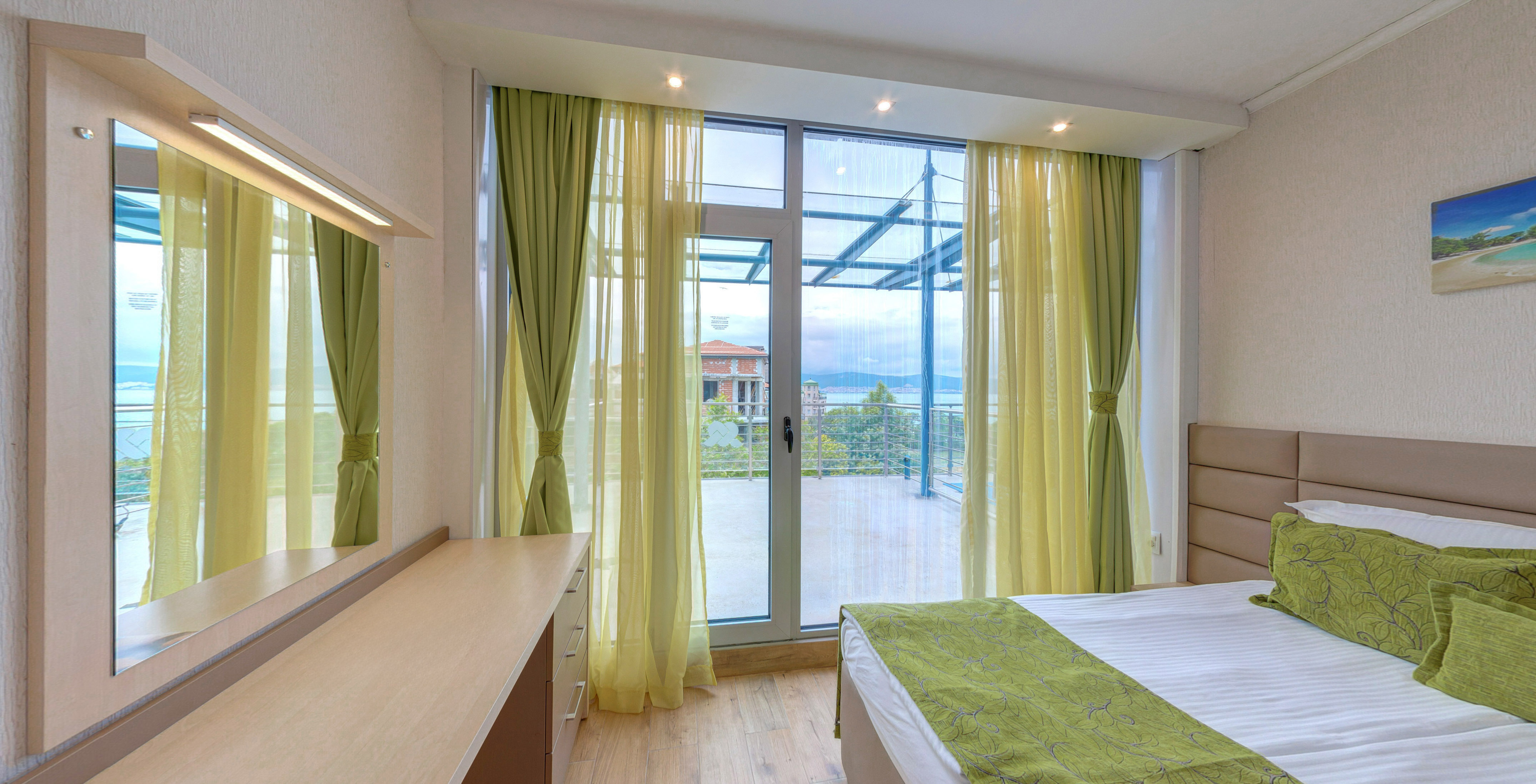 a bedroom with green curtains and a window