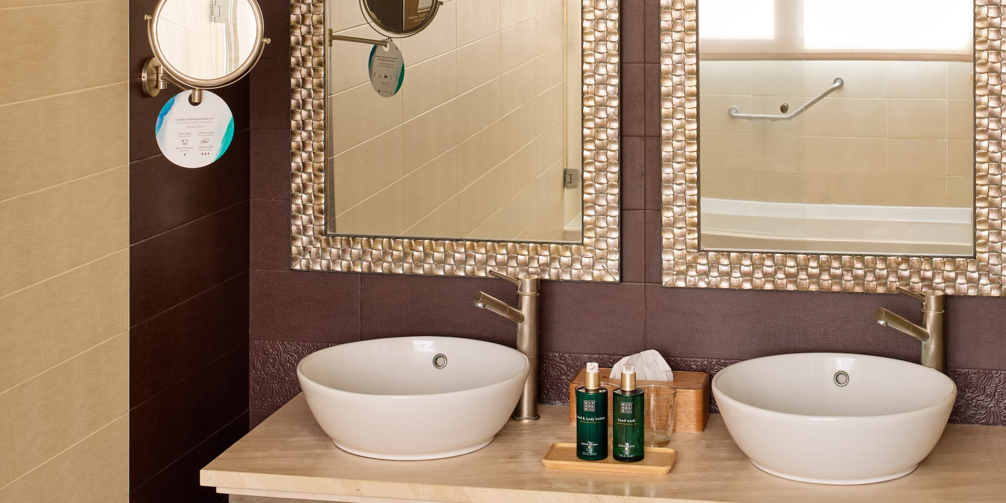 a bathroom with two sinks and mirrors