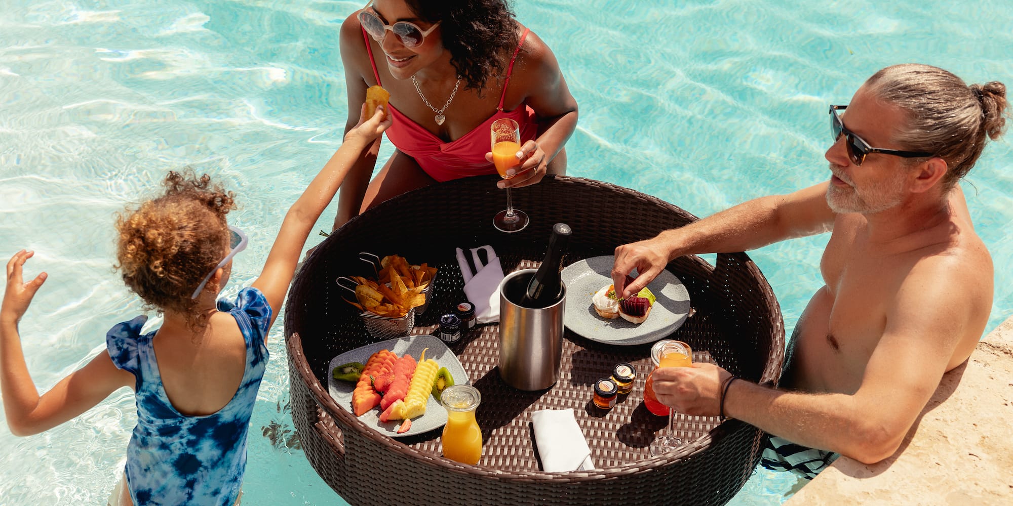 a group of people in a pool eating food
