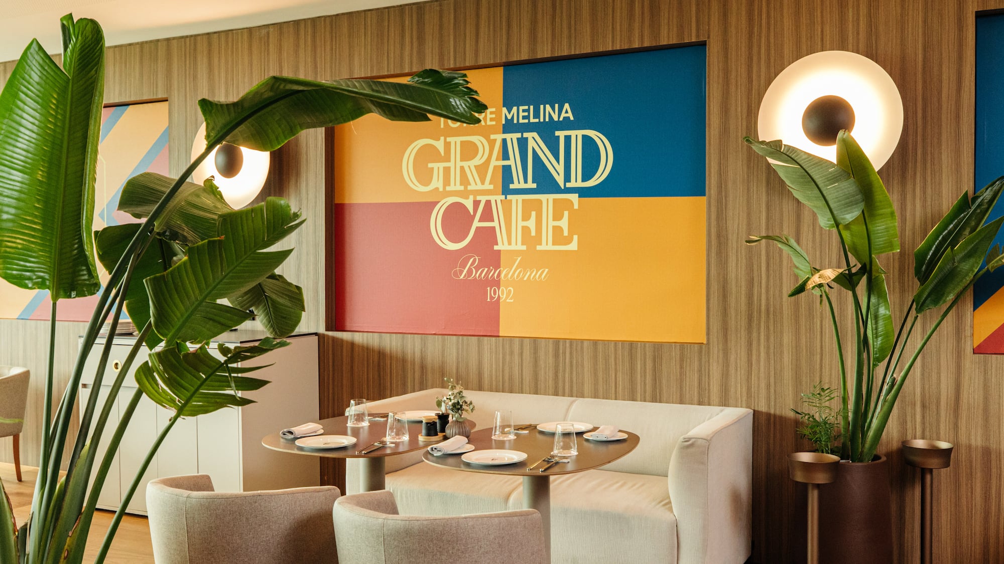 a room with a couch and tables and plants