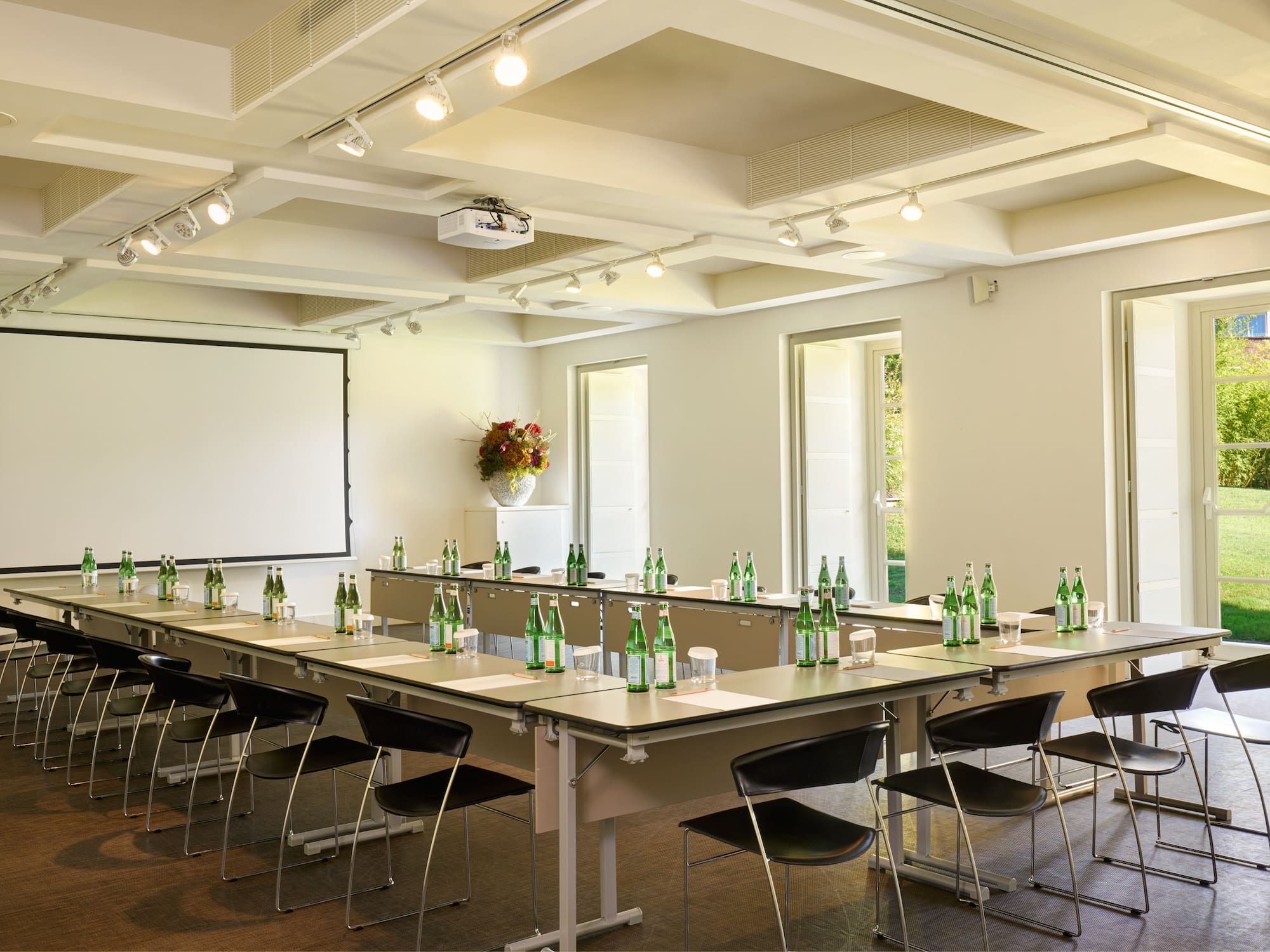 a room with a white board and tables with bottles of beer
