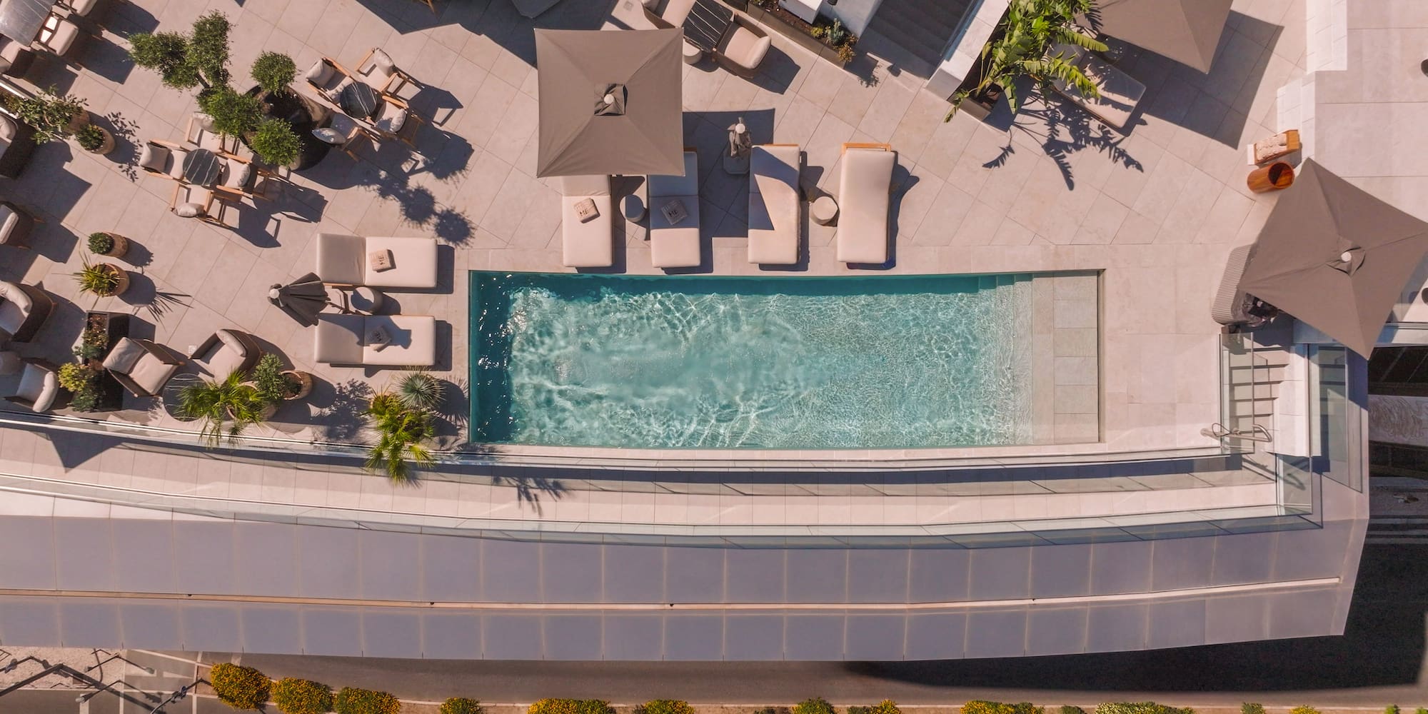 a pool with lounge chairs and a roof