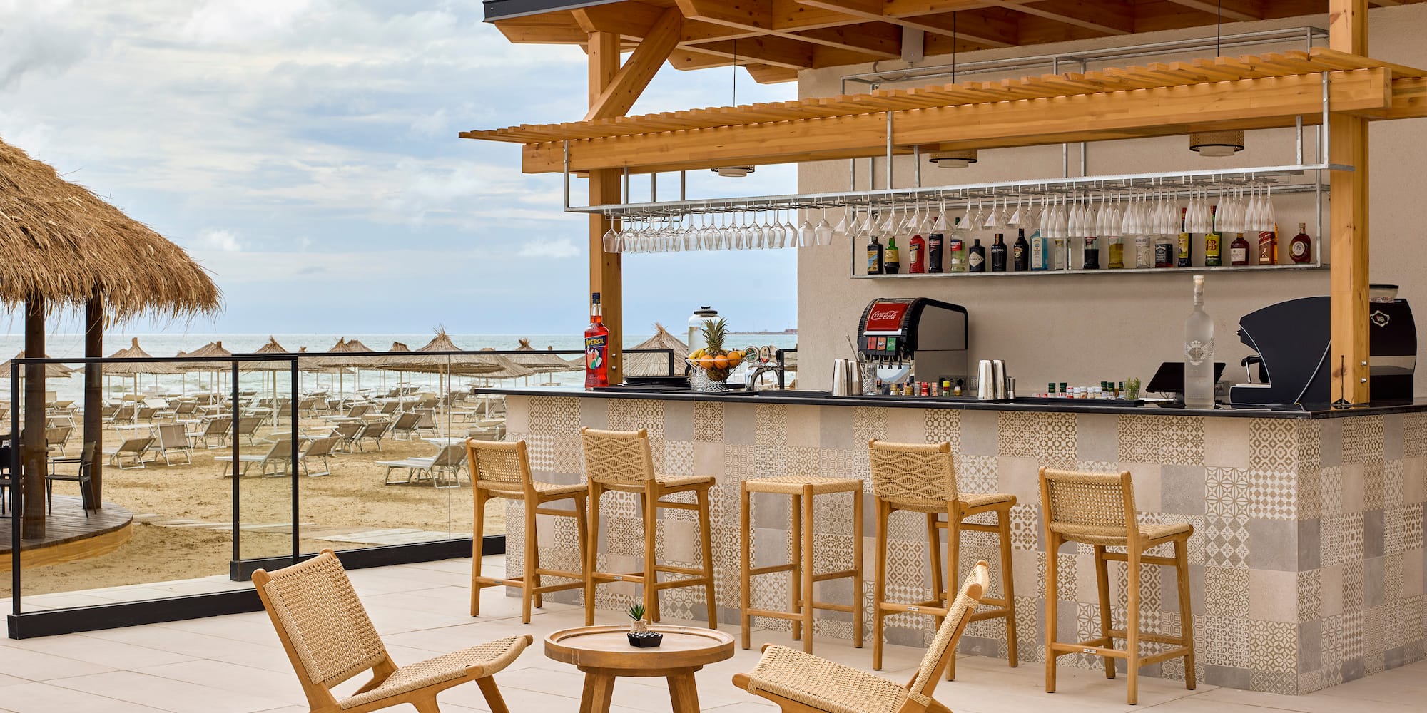 a bar with chairs and a table on a deck