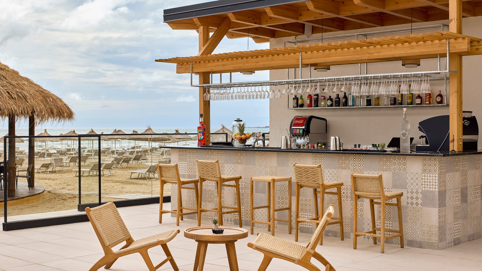 a bar with chairs and a table on a deck