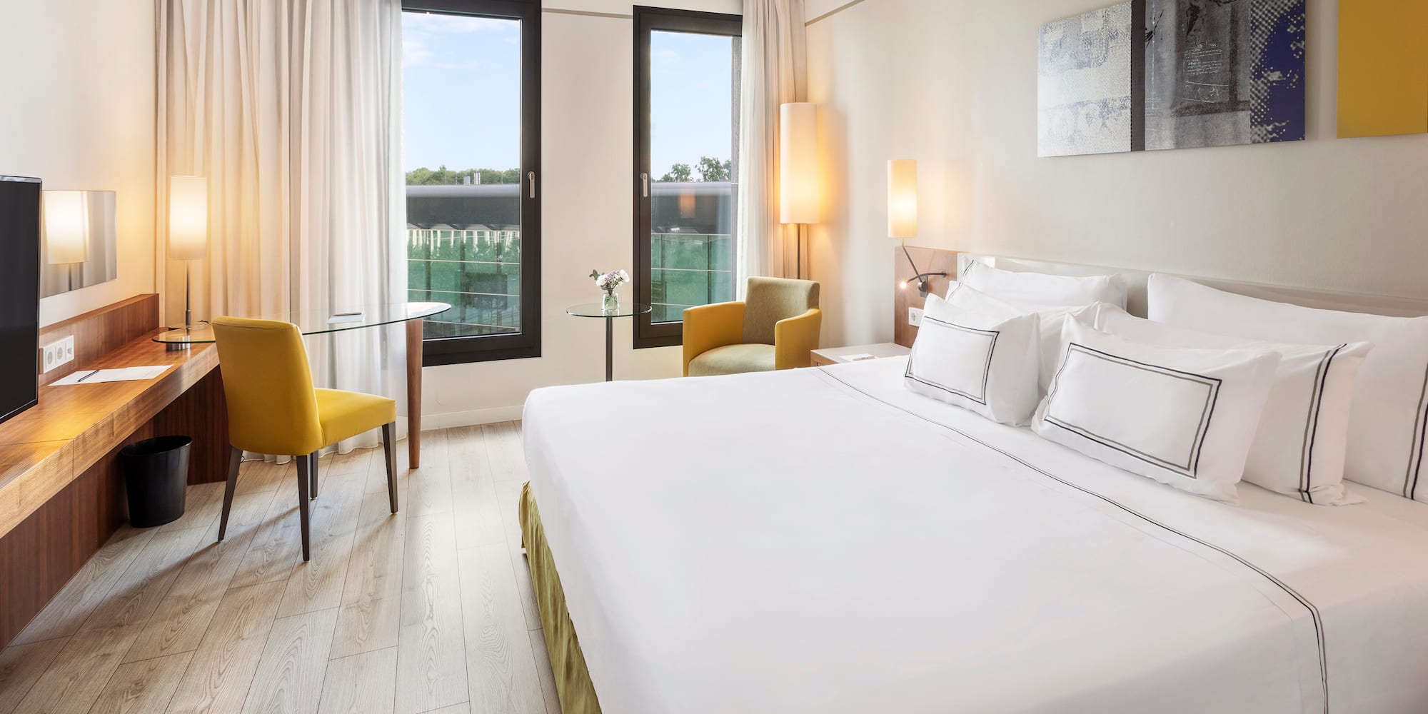 a room with a bed and chairs