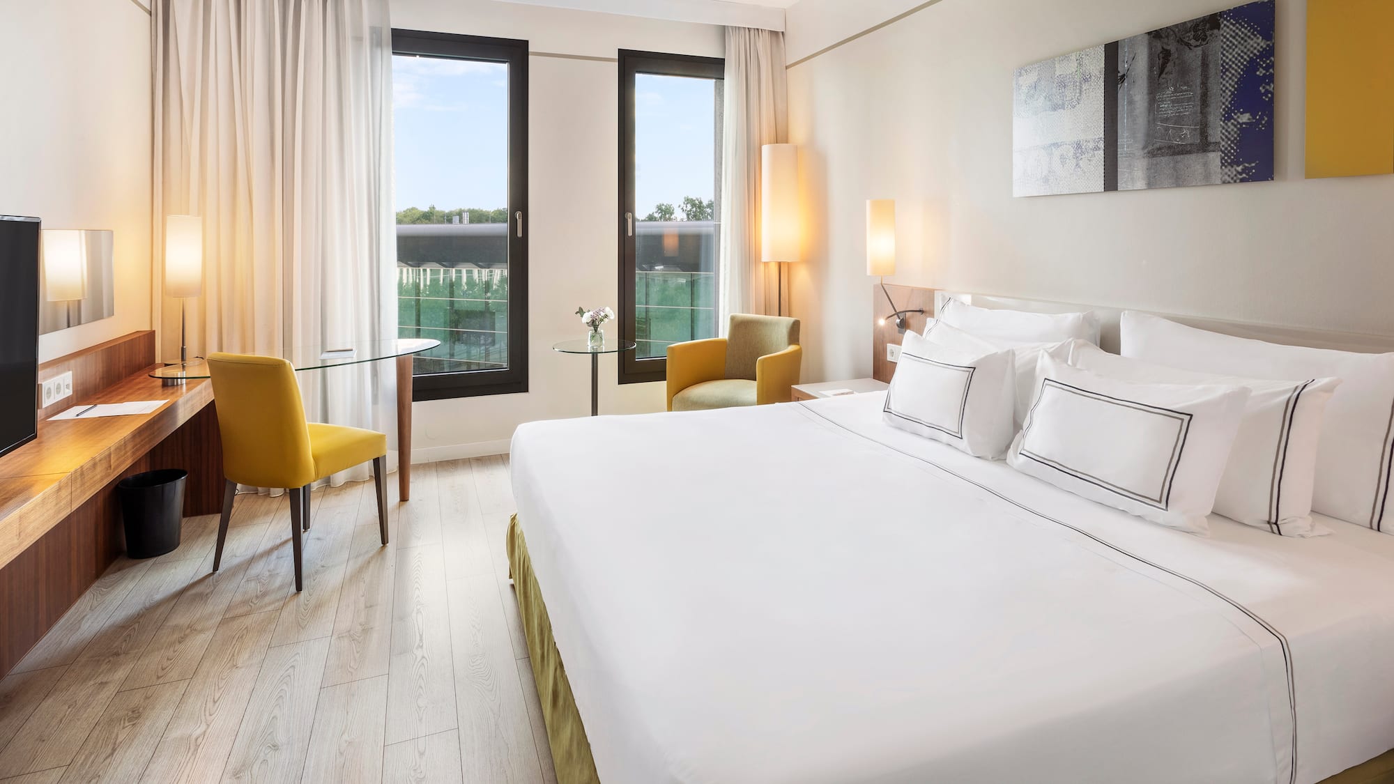 a room with a bed and chairs