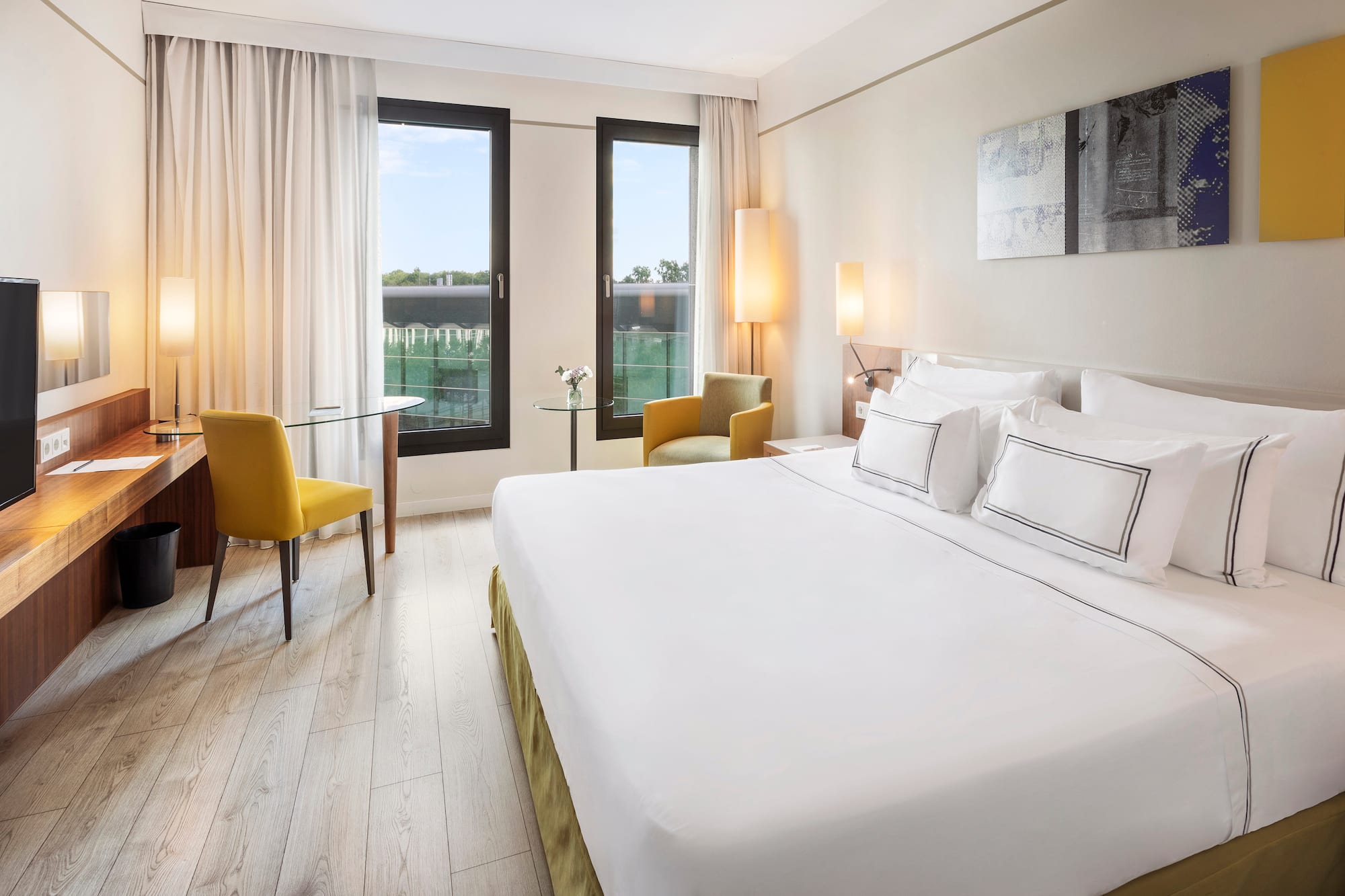 a room with a bed and chairs